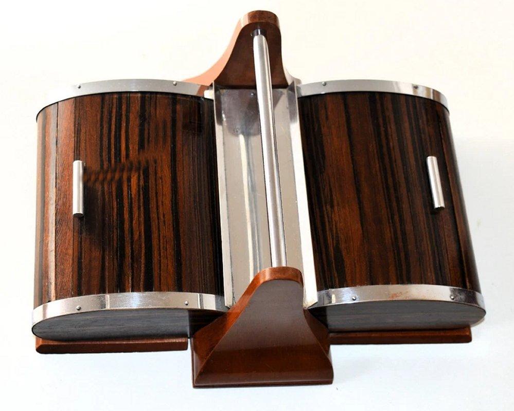 For your consideration is this superbly iconic Art Deco walnut cady. Features a pair of back-to-back roll top tambour style cigar boxes divided by a polished aluminium dividing 'shelf' are supported on a wooden base together with a central carrying