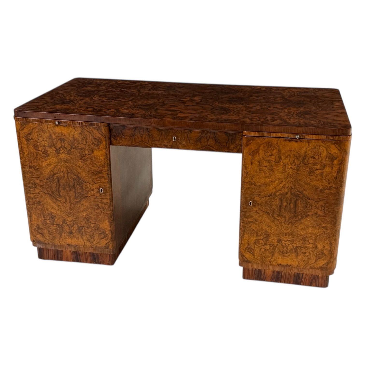Art Deco Walnut Rosewood Burl Wood Desk, 1930’s.  Made in Czechoslovakia.  Restored absolutely beautiful.
Measures 58.75” long 31” Dee 31” tall