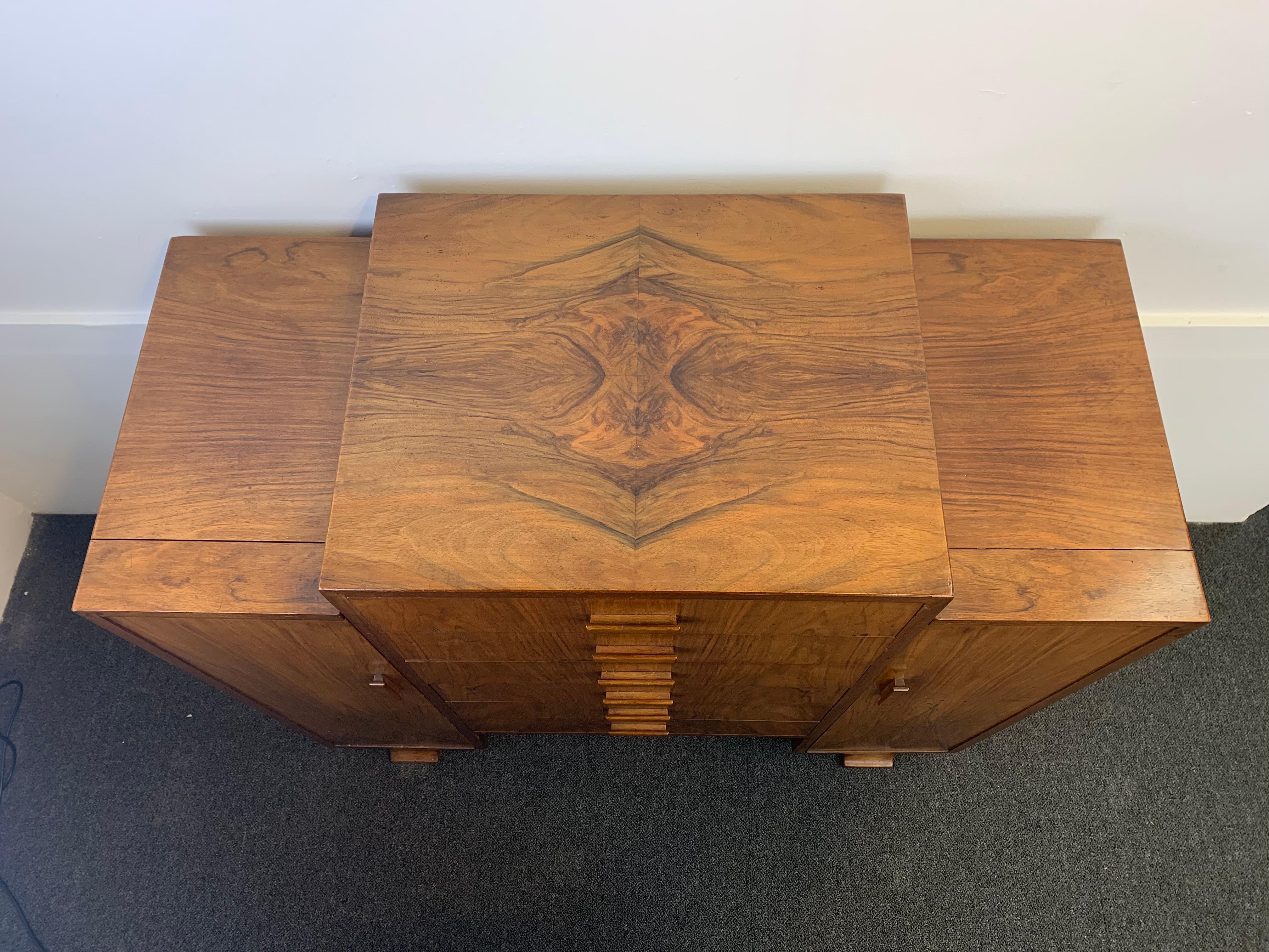 A walnut Art Deco cabinet designed to hold sheet music.
Made by the quality furniture makers, Merryweather and Son, of Holloway,
The central section consists of six drawers with drop down hinged fronts to allow easy access for sheet music or could