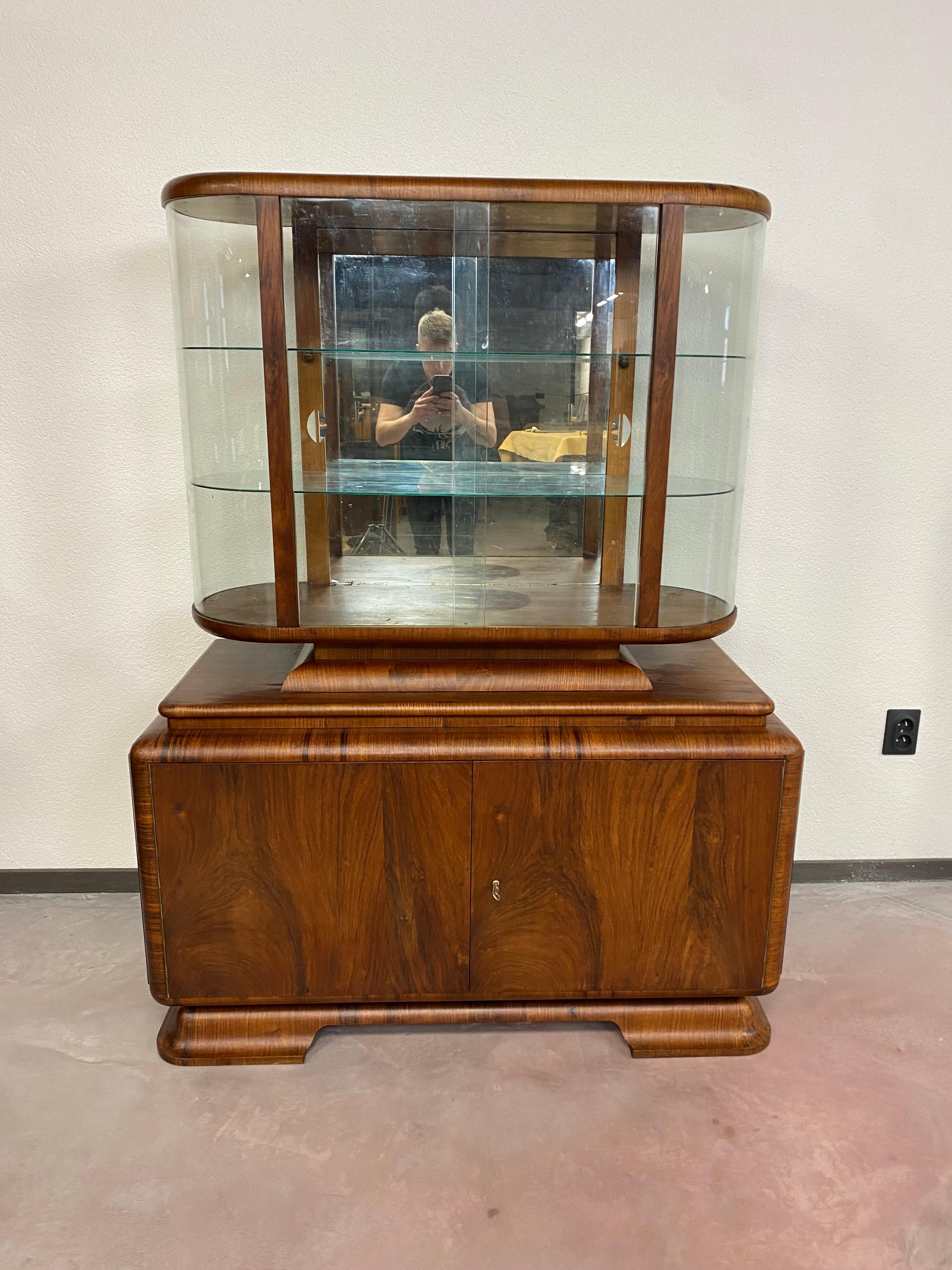 Art deco walnut showcase in very good condition with signs of usage.