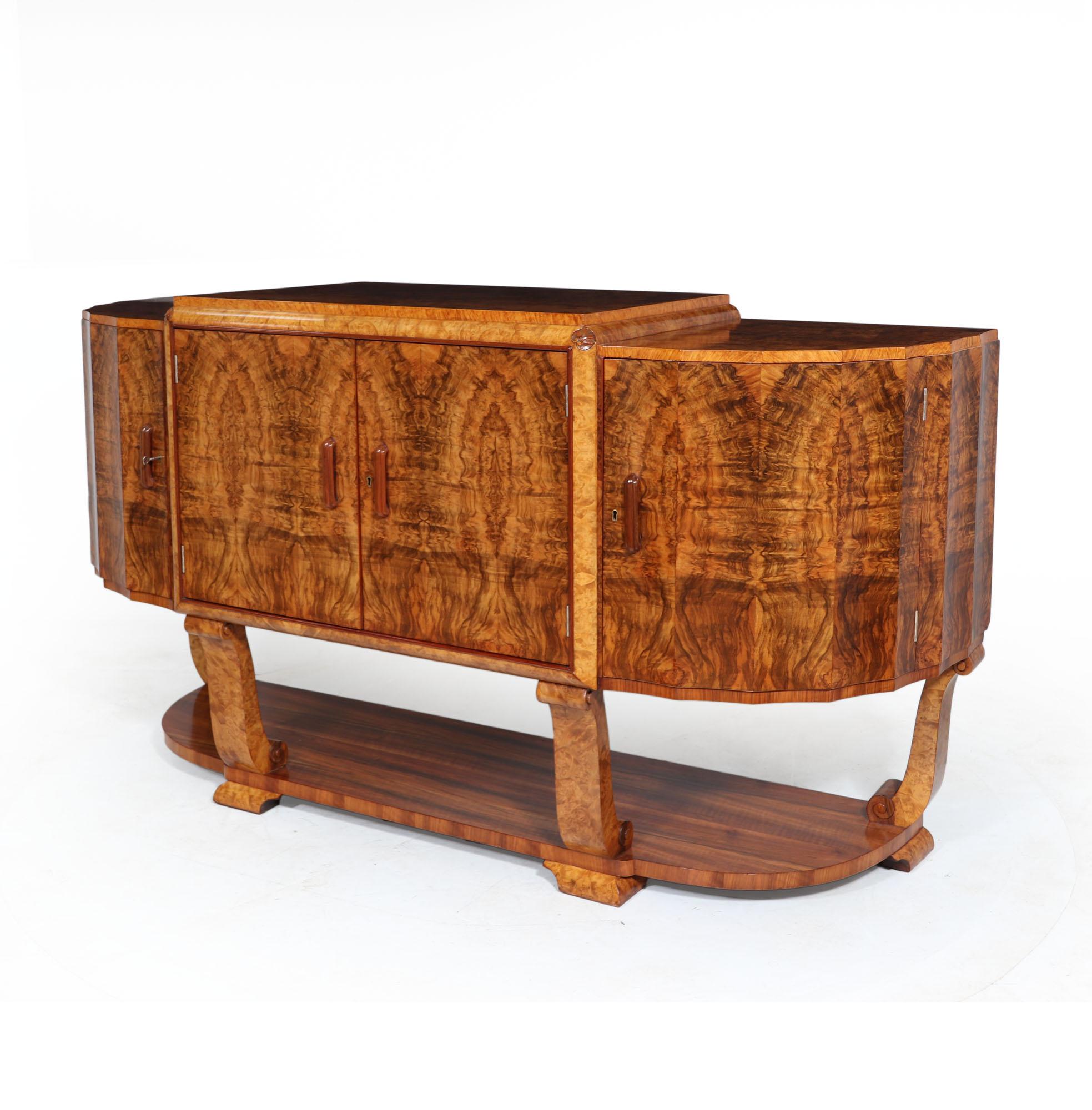 Art Deco sideboard by Hille.
An Art Deco sideboard produced in figured walnut by Hille in the 1930s, the sideboard is of exceptional quality featuring two central doors with drawers behind, either side are a further two doors these are curved and