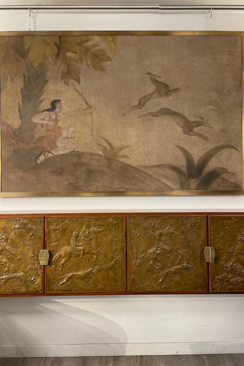 Unique Deco-style credenza-cabinet: with a length of 179cm, it has front panels made of gilded stucco depicting scenes with men and horses. The frame of the sideboard is made of wood and walnut, the handles are brass and are original.

The interior