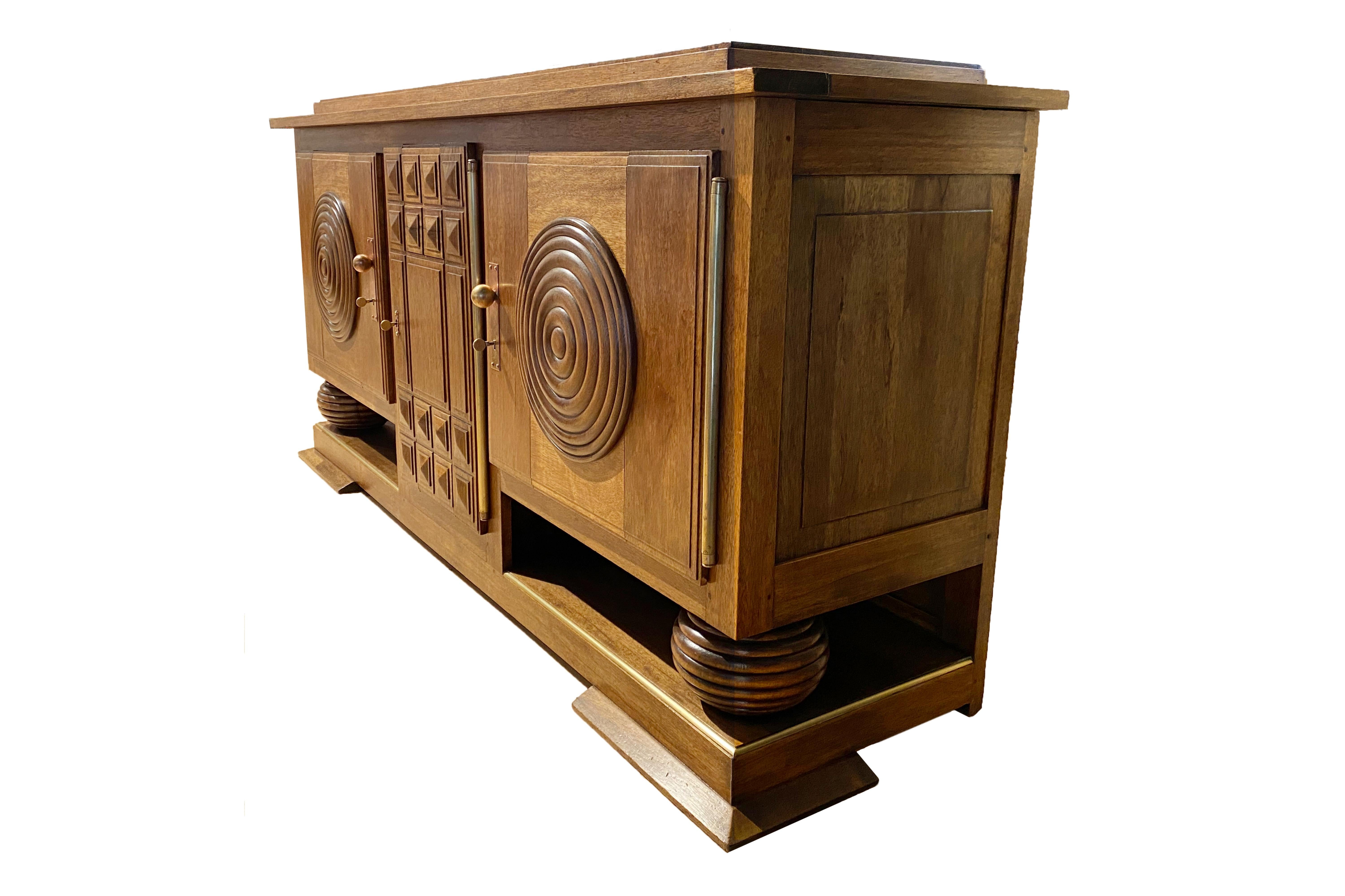 French Africanist Art Deco sideboard.
Made with solid walnut.
Brass details.
Three door sideboard.
The central door has 3 drawers.
Circa 1940, France.
Very good vintage condition.
Art Deco, sometimes referred to as Deco, is a style of visual