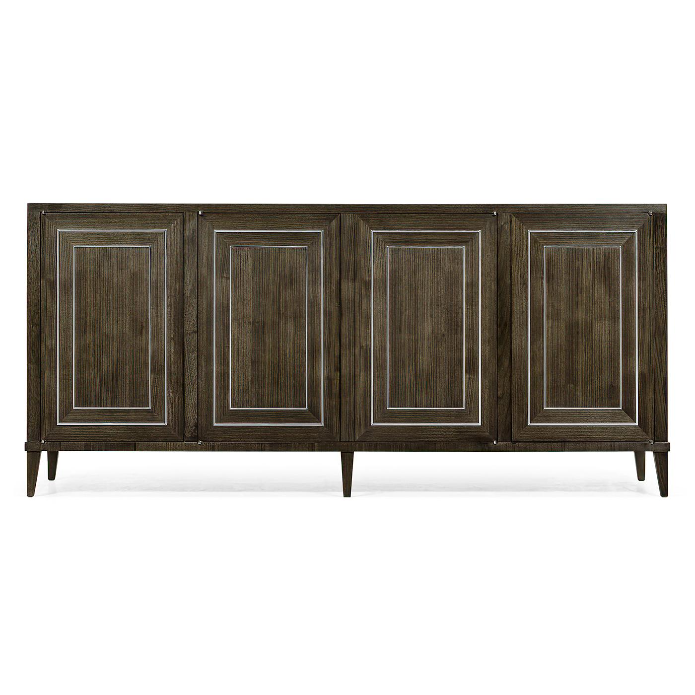 An Art Deco style greyed walnut sideboard with stainless steel inlaid details. The four cabinet doors open to reveal two open cabinets on either end with adjustable shelves and the double center section opens to reveal a long drawer and lower shelf.