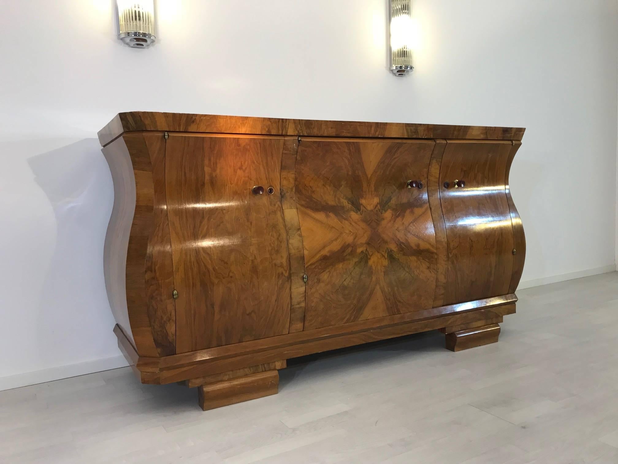 Three doored Art Deco sideboard with an elegant tulip body. This French masterpiece offers a unique combination of walnut wood and Art Deco design. Typical buffet from a stunning furniture period.

 Original piece from France, 1920s
 Clean