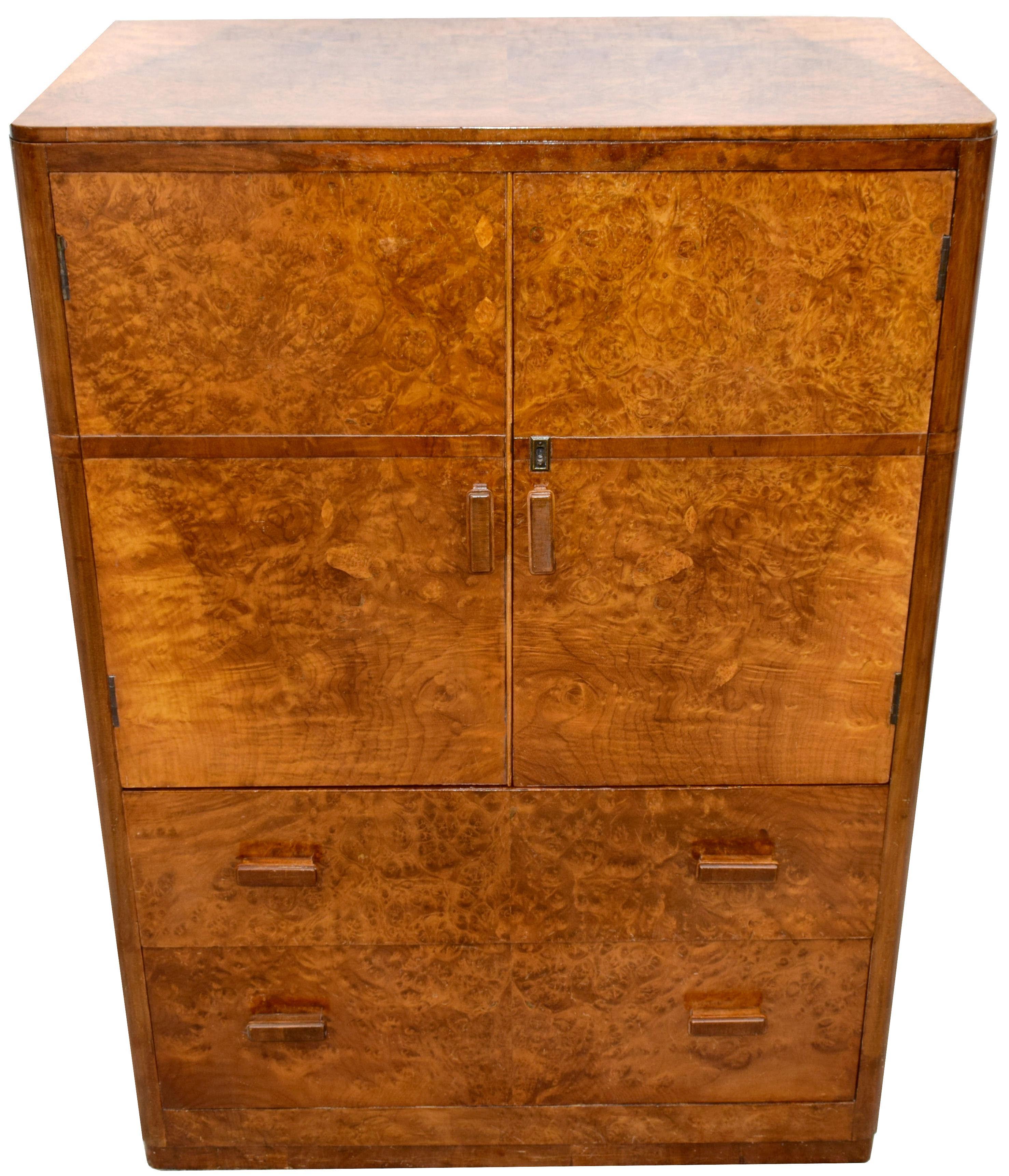 For your consideration is this English Art Deco walnut two-door, two-drawer single-piece tallboy, circa 1930 and in superb original condition. Not only does this tallboy look the part but it's extremely useful too having a very generous interior to