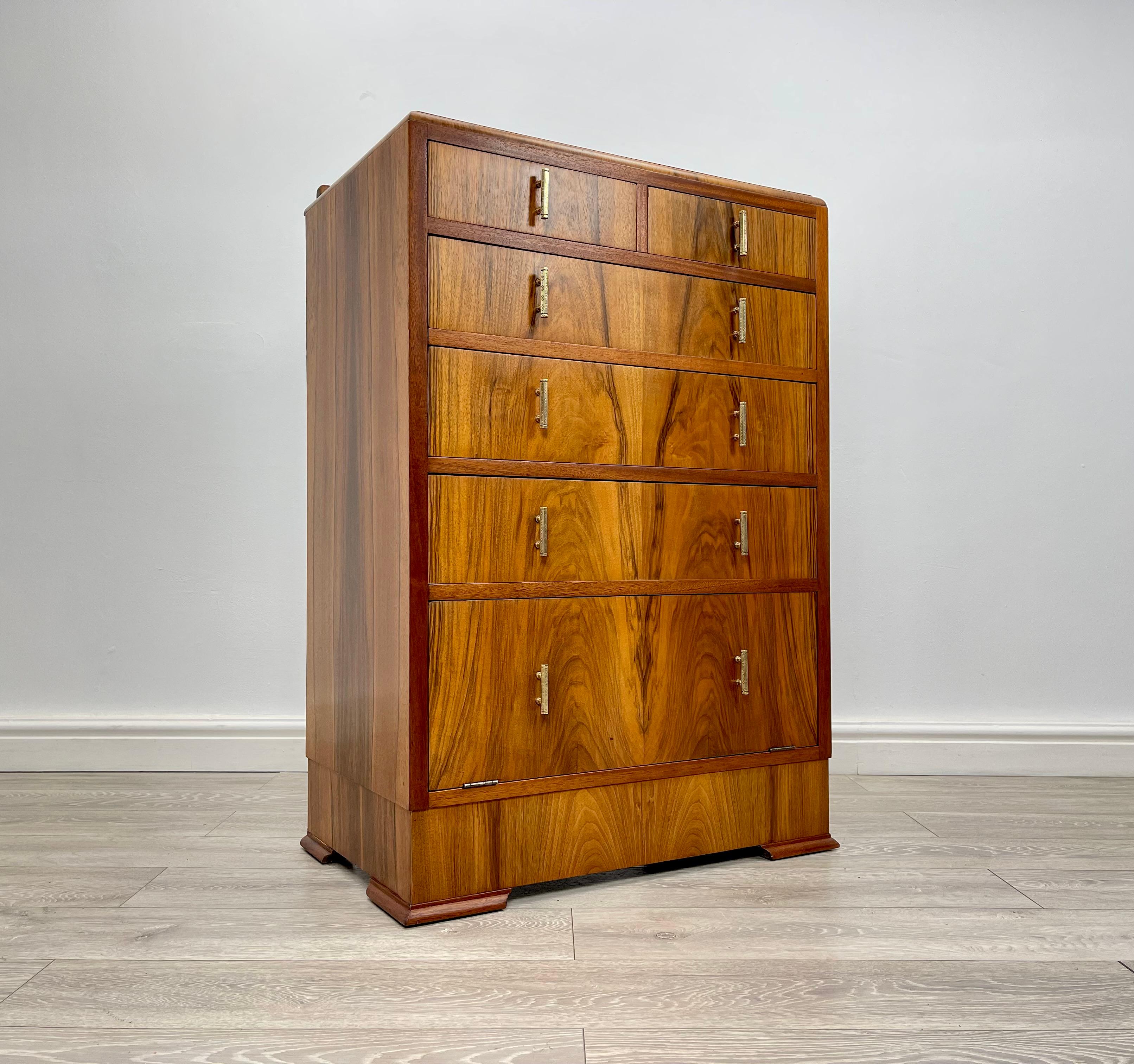 CHEST OF DRAWERS 
Stunning Art deco walnut tallboy chest of drawers circa 1930 .

The chest of drawers has stunning walnut grain and golden patina throughout , the chest of drawers is fitted with solid brass pull handles .

There’s five drawers with