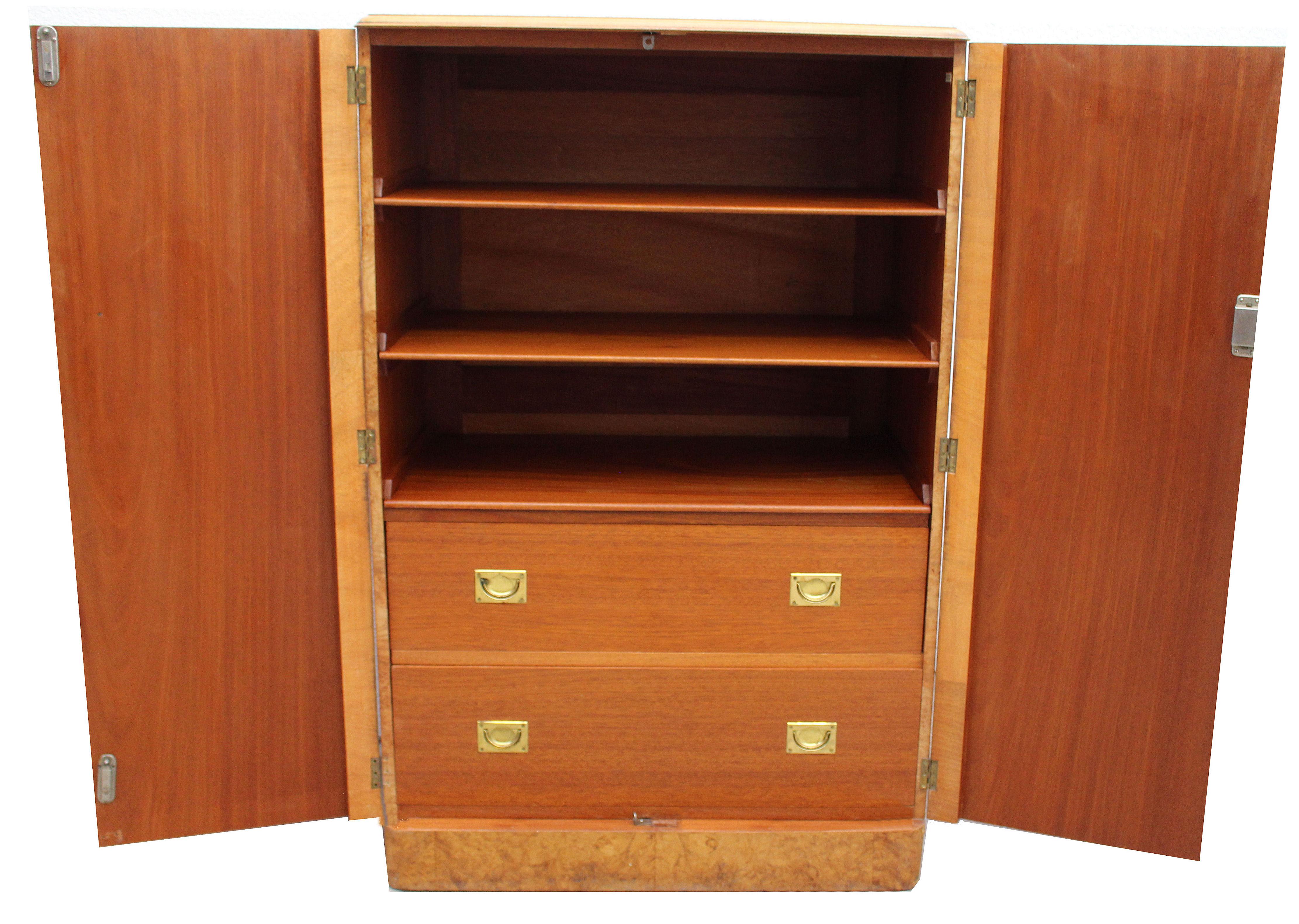 For your consideration is this extremely stylish English Art Deco Blonde heavily figured Walnut two-door, two drawer single-piece tallboy, circa 1930. Not only does this tallboy look the part but it's extremely useful too having a very generous