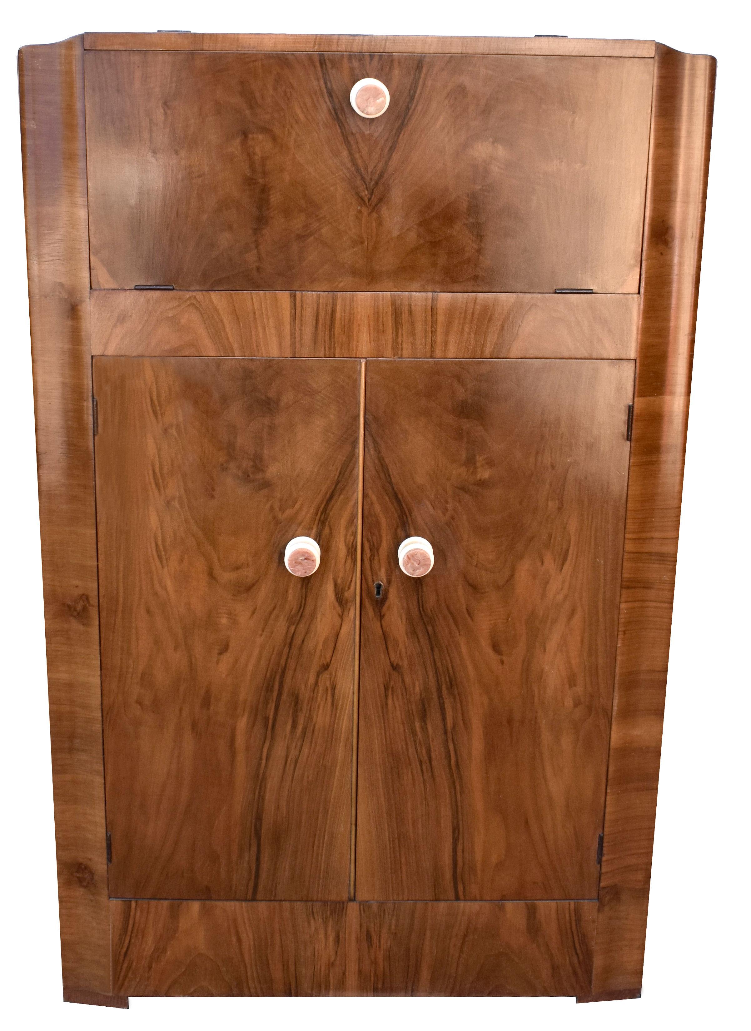 Beautiful 1930's English Art Deco walnut upright cocktail cabinet, dry bar, every home should have one of these ! Features a drop down top which reveals a mirrored interior and storage for bottles and glasses. A generously sized cupboard below