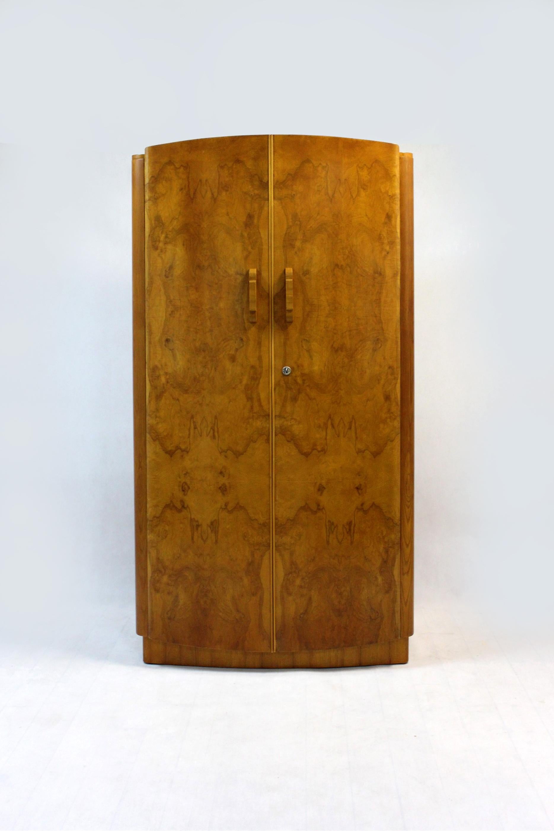 This Art Deco wardrobe was designed by Jindrich Halabala and produced by UP Zavody in Czechoslovakia in the 1940's. 
It has two doors, an internal clothes rail and five shelves.
 