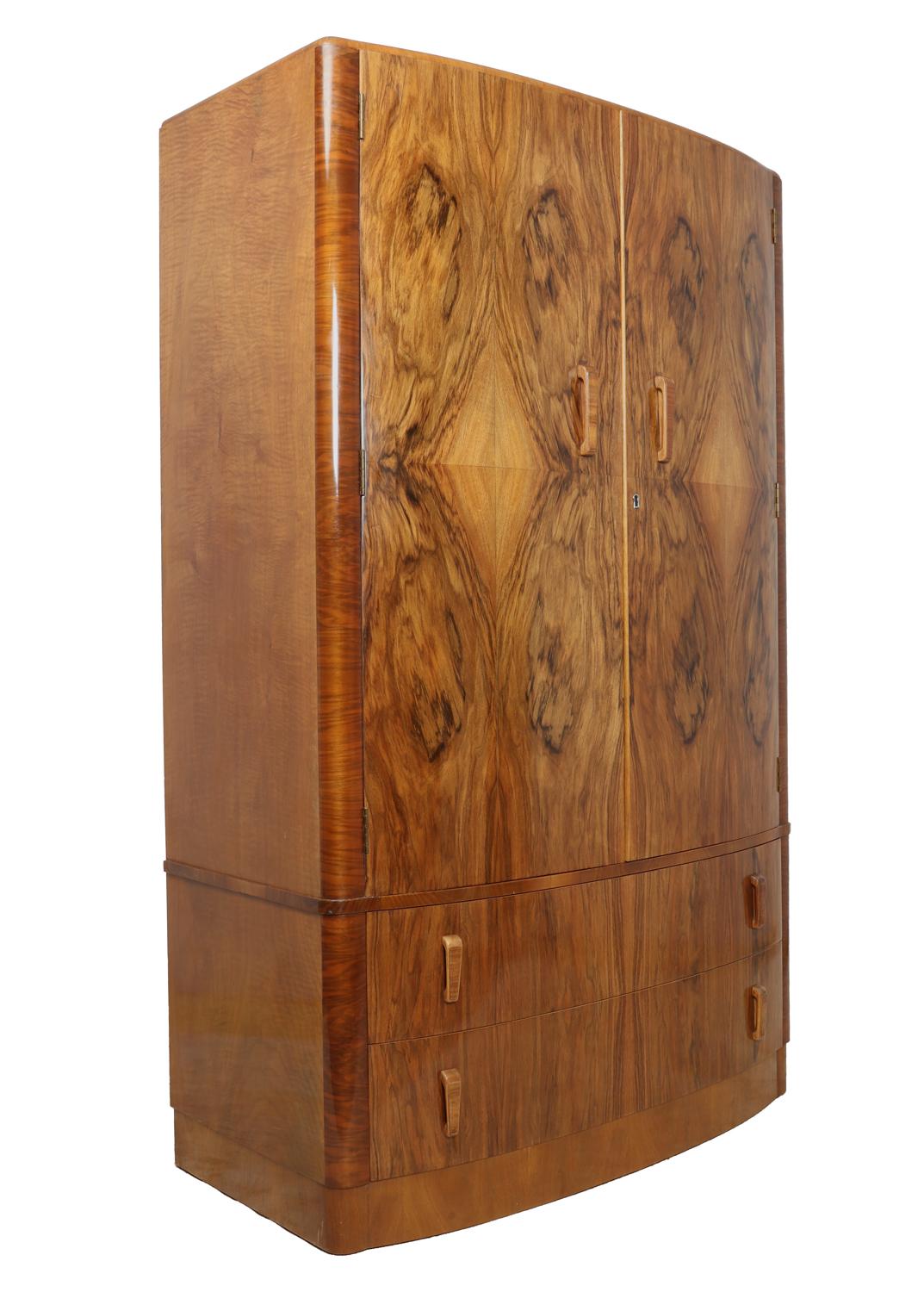 Art Deco walnut wardrobe, circa 1930
A bow fronted two door wardrobe with two long drawers underneath and fitted interior, the wardrobe has been polished and is in excellent condition

Age: 1930

Style: Art Deco

Material: Walnut

Origin: