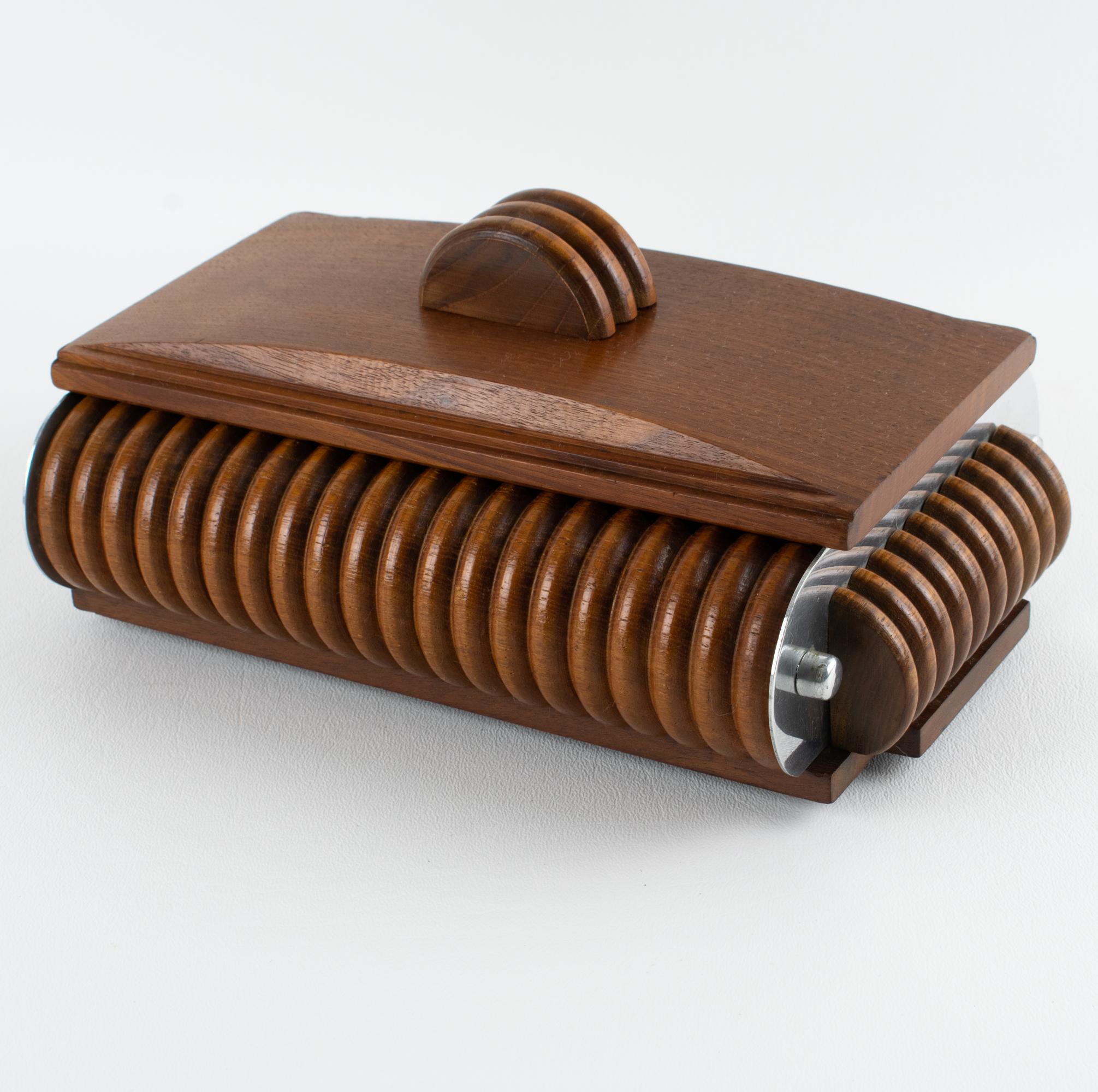 This stunning decorative lidded box dates from the Art Deco period. The piece was expertly crafted in France circa 1930. The important rectangular shape is made of varnished walnut wood, all carved and shaped. The modernist shape is contrasted with