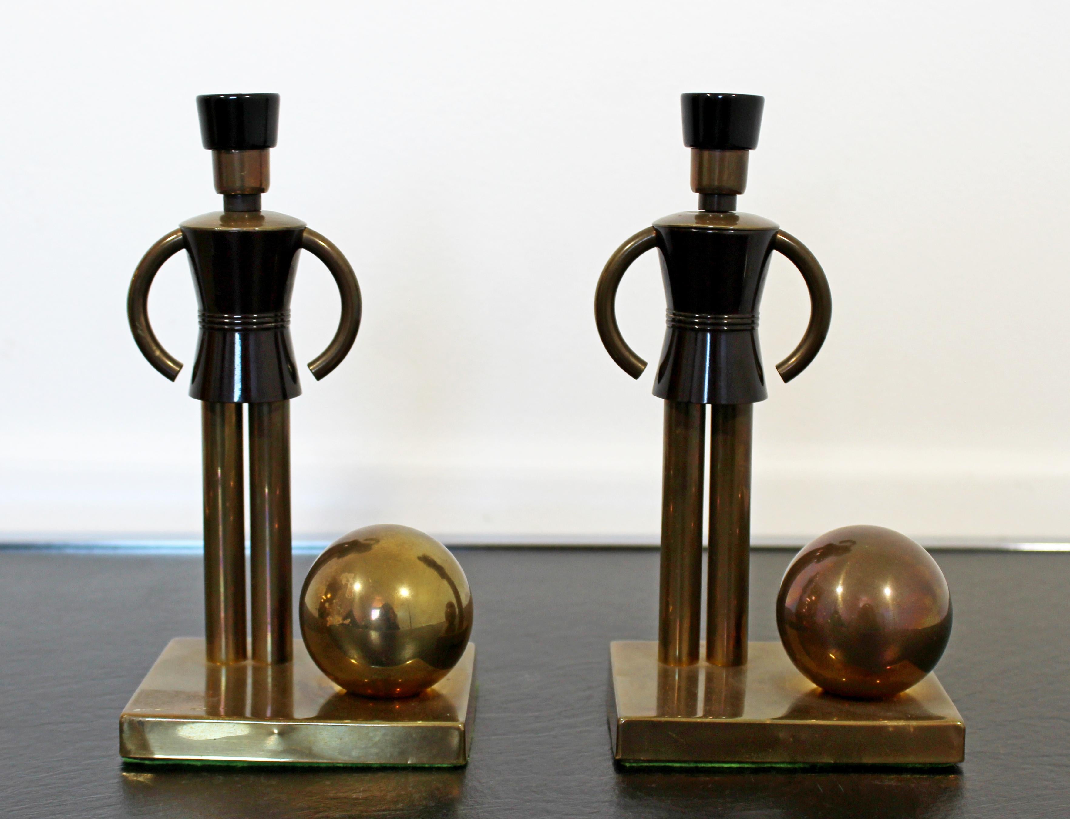 For your consideration is a fantastic pair of brass and Bakelite bookends, toys for chase, by Walter Von Nessen. In very good vintage condition, with a patina to match the age. The dimensions of each are 4
