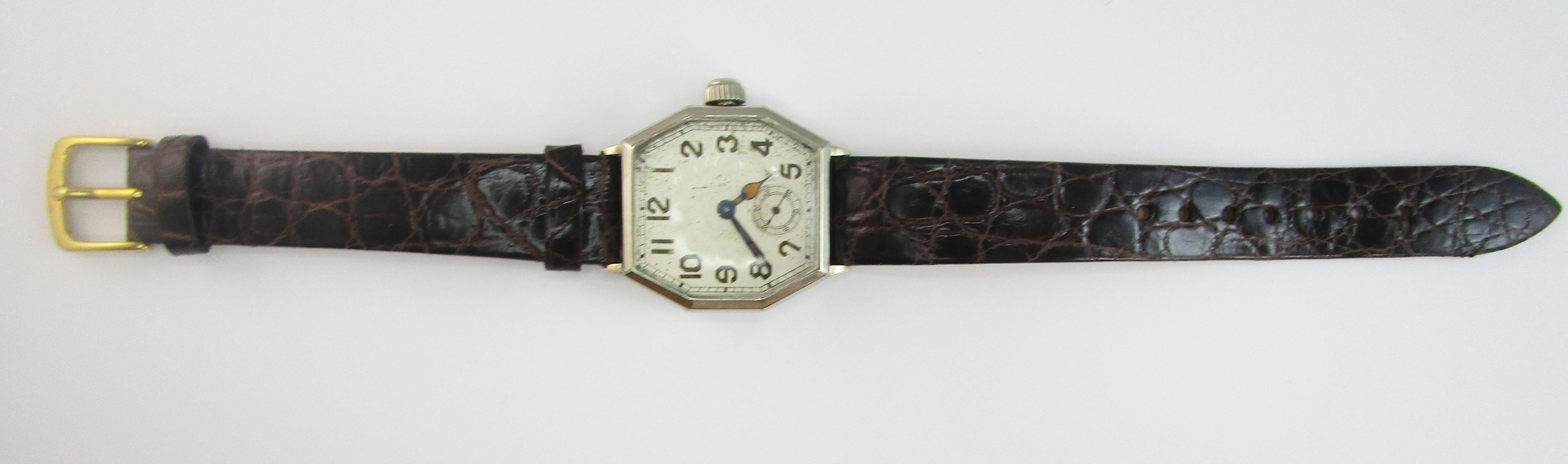 This is a stunning Deco Waltham 17 jewel watch with an elegant octagonal case. The hands have a subtle terracotta-colored detail. This watch has a small seconds sub-dial. The case and face are in excellent condition! This watch has been given a new
