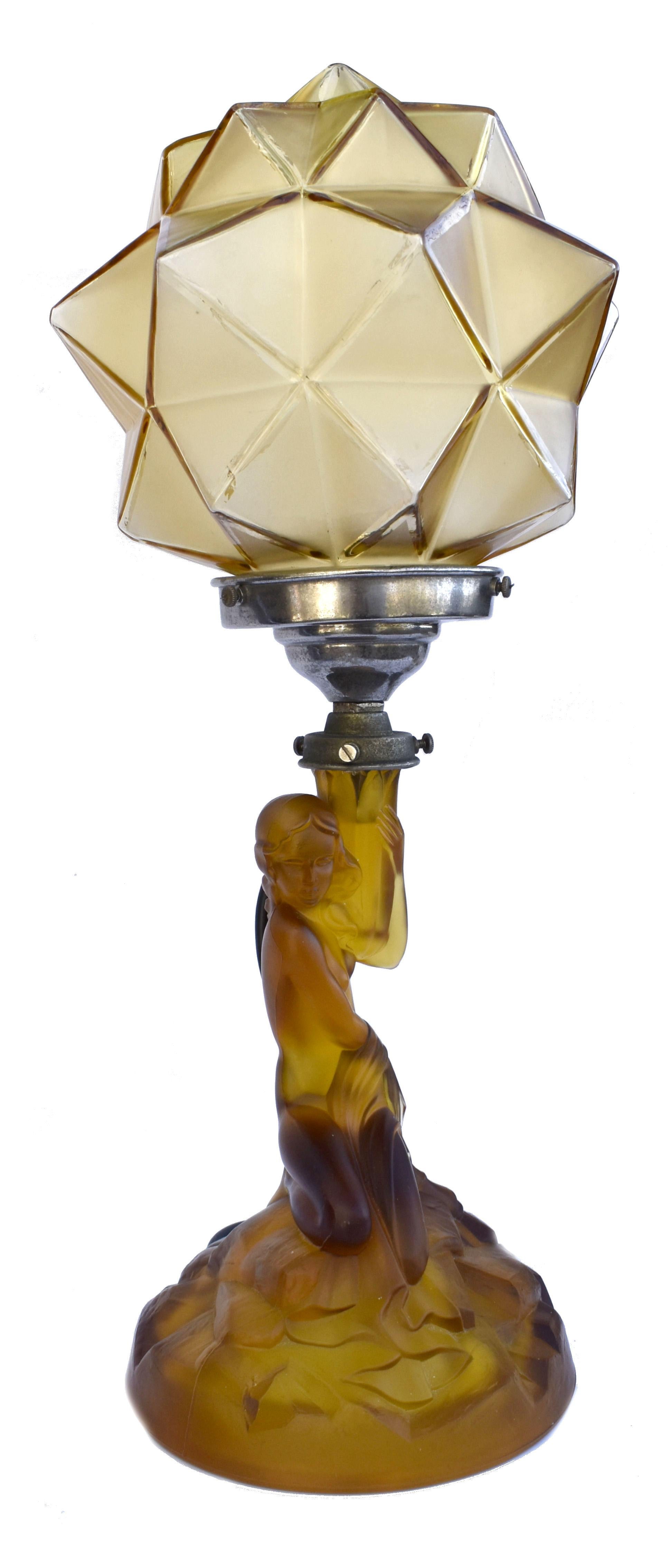 For your consideration is this tall and very elegant and original Walther and Sohne amber glass table lamp, circa 1930's. Features female nude to create the column of the lamp with a spiked glass shade. The amber coloured glass in excellent