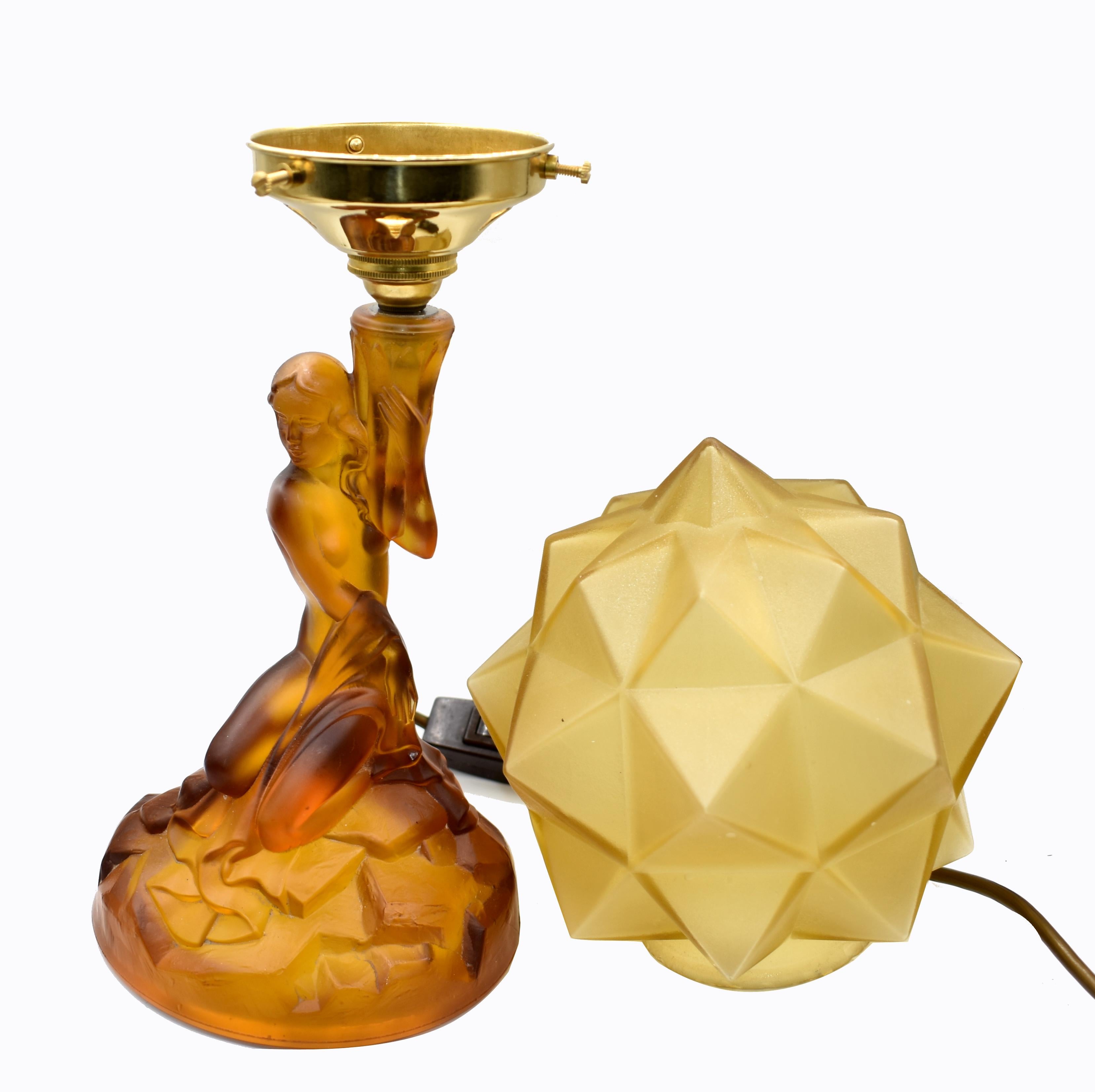 For your consideration is this tall and very elegant and original Walther And Sohne amber glass table lamp, circa 1930s. Features female nude to create the column of the lamp with a segmented glass shade. The amber colored glass in excellent