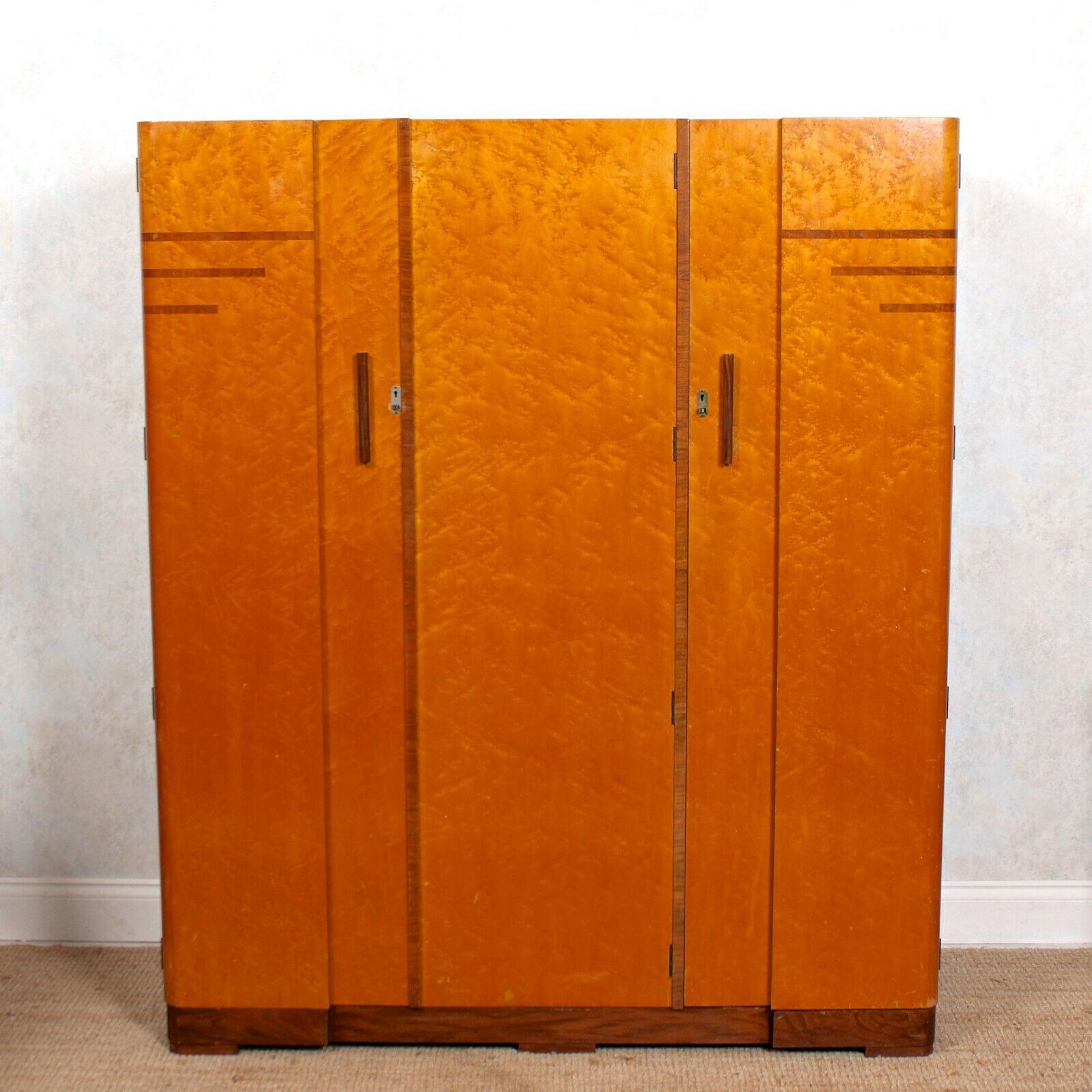 A fine quality Art Deco bird’s-eye maple compactum wardrobe.
The inlaid doors mounted with good handles and enclosed a fitted interior comprising hanging rails, hooks, shelving, glazed cupboard, tray and drawers mounted with good brass inset