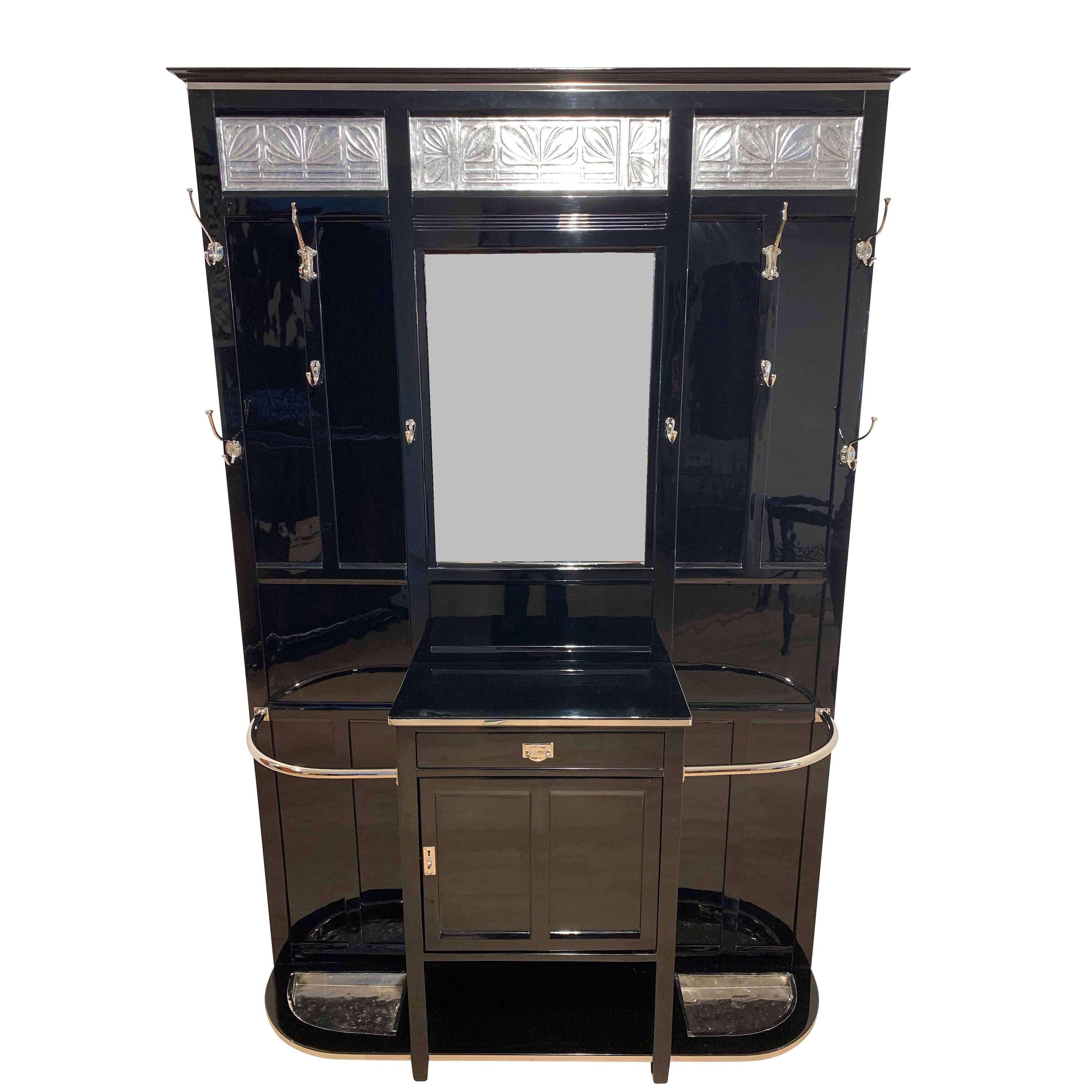 Outstanding, big and original Art Deco wardrobe with mirror from France, circa 1930.

Excellently restored condition. Glossy piano varnish finish in a deep black.
Silver plated leaves decor at the top. All original, newly galvanized (nickel-plated)