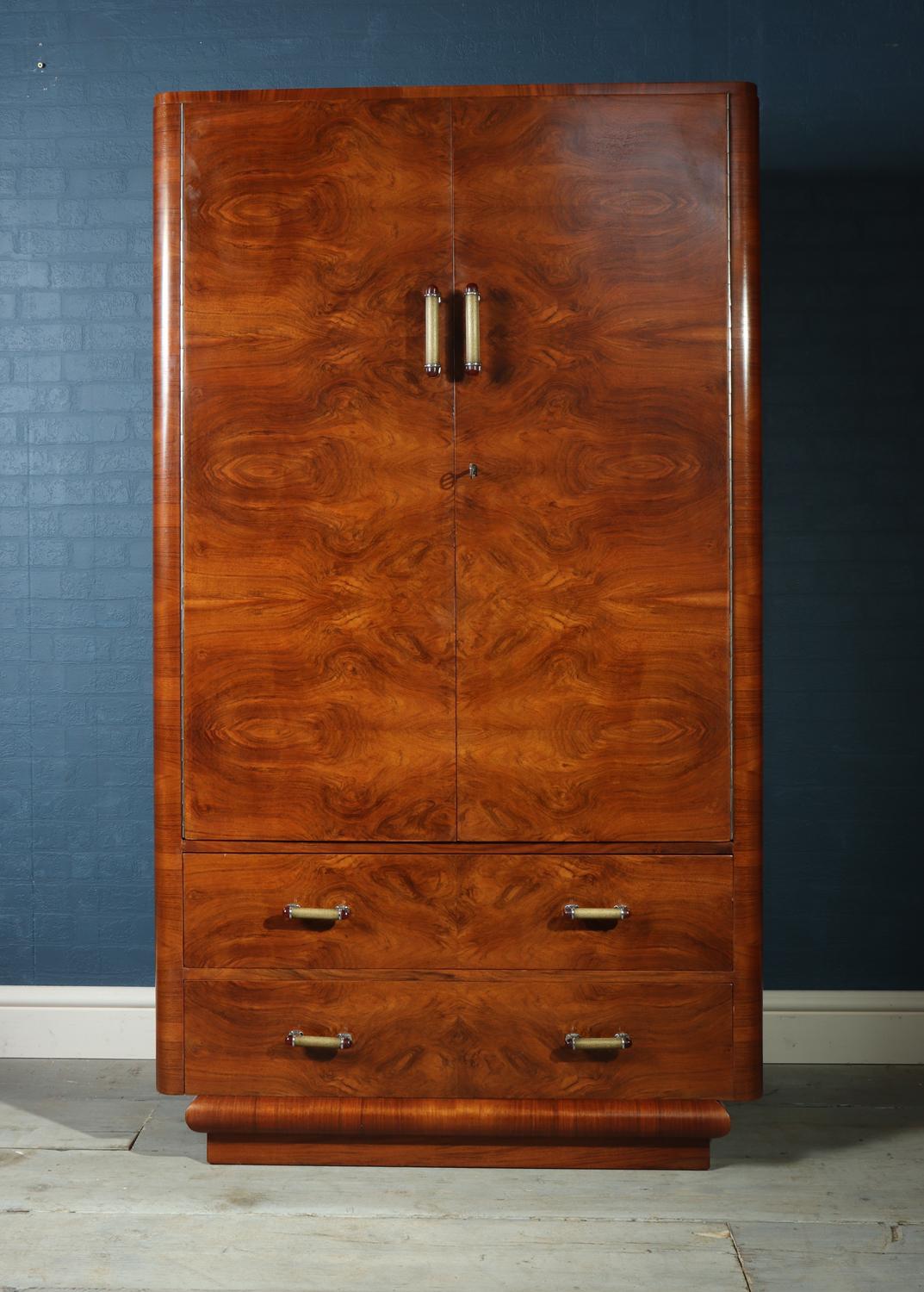 Art Deco wardrobe in walnut circa 1930
This art deco wardrobe has cupboards above with two drawers below, the interior has a hangin rail to the right and shelves to the left, the wardrobe has been polished and is in excellent condition