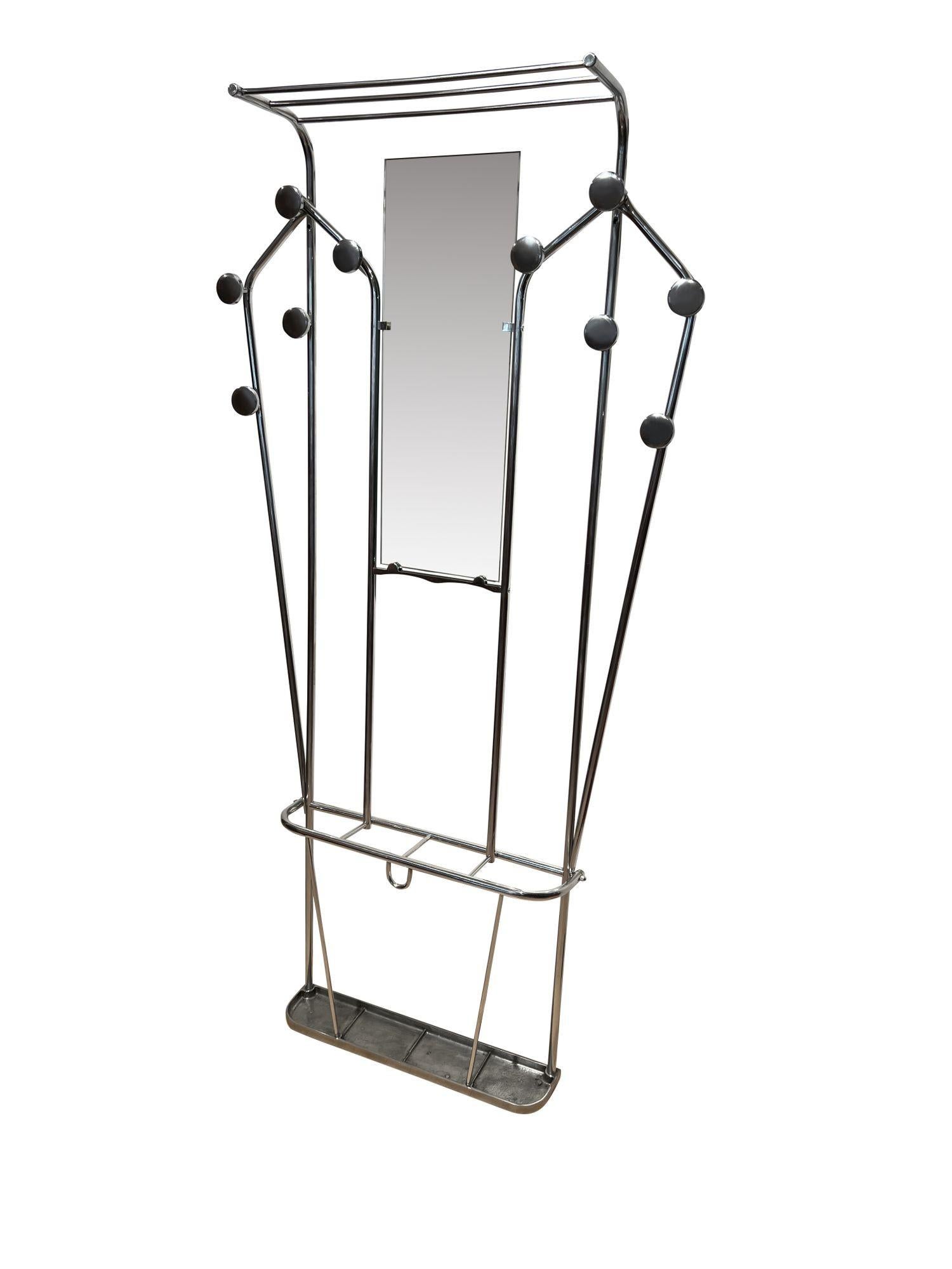 Art Deco Wardrobe with mirror, aluminum tubes, France circa 1930
 
Art Deco wardrobe or wall coat rack
 
Aluminum tubes, newly polished to high gloss 
Mirror added in the center
10 hangers
Above with hat shelf 
Below a metal shelf as