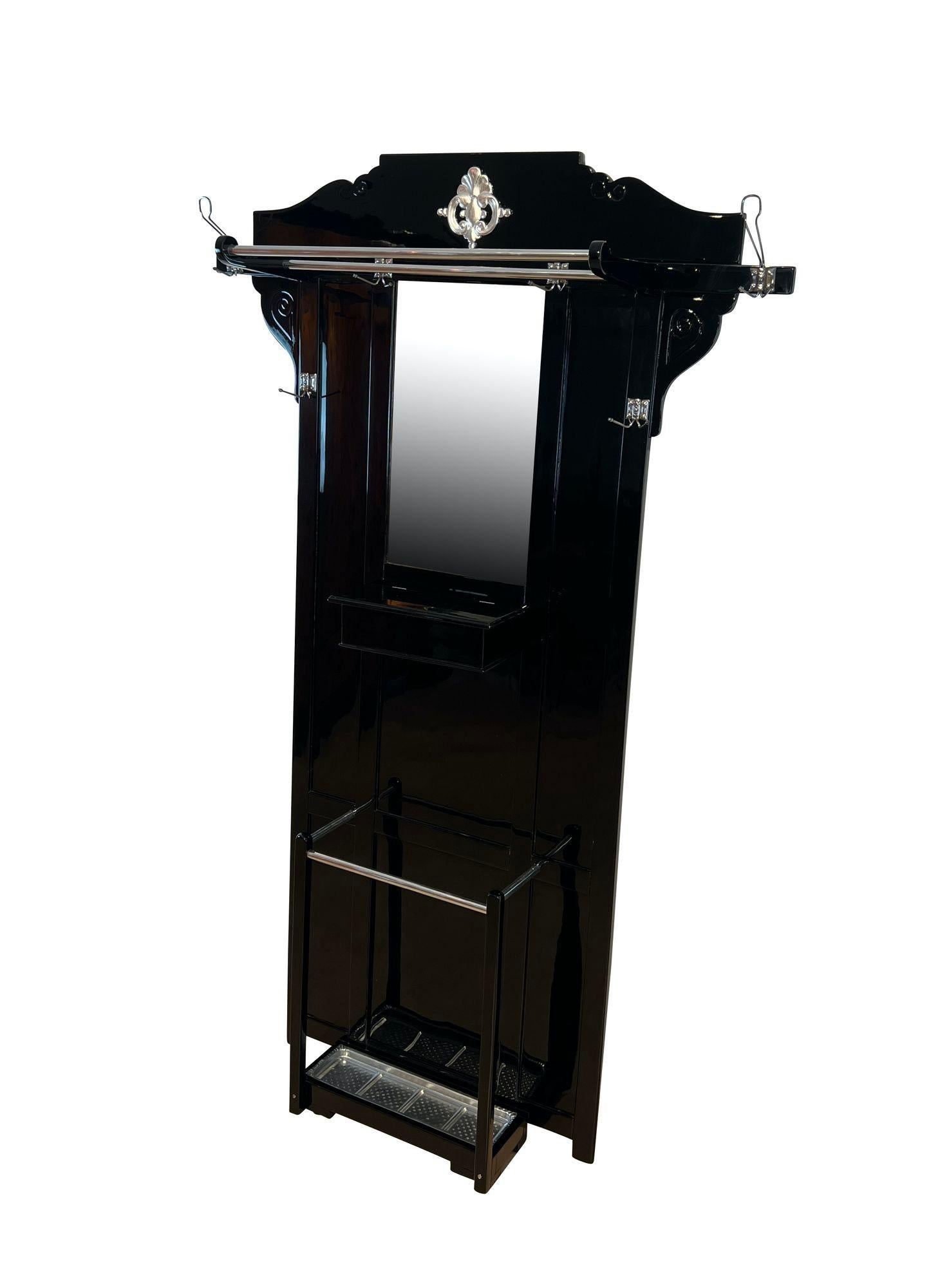Original Art Deco wardrobe in black piano lacquer and silver-leaf from Germany around 1925.
Oak and beech solid wood, lacquered in black high-gloss with piano lacquer. Silver-leaf ornament in the center at the top. Original mirror glass with facet