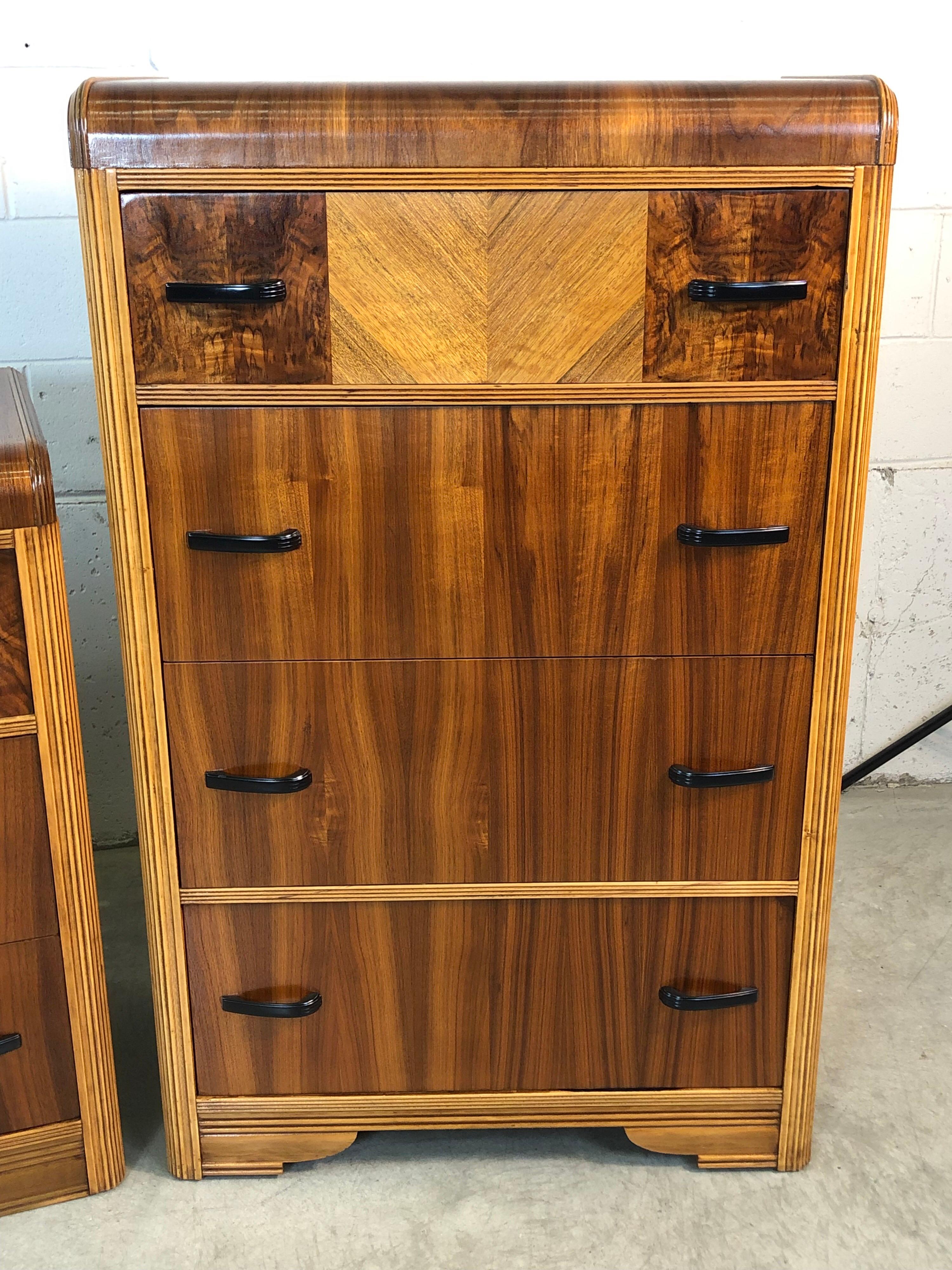 Vintage Art Deco pair of waterfall dressers. One is a tall boy and the other is a lowboy. They are a matching pair with a mix of walnut, mahogany and maple woods. The tall dresser has four deep drawers and the low dresser has three deep drawers.
