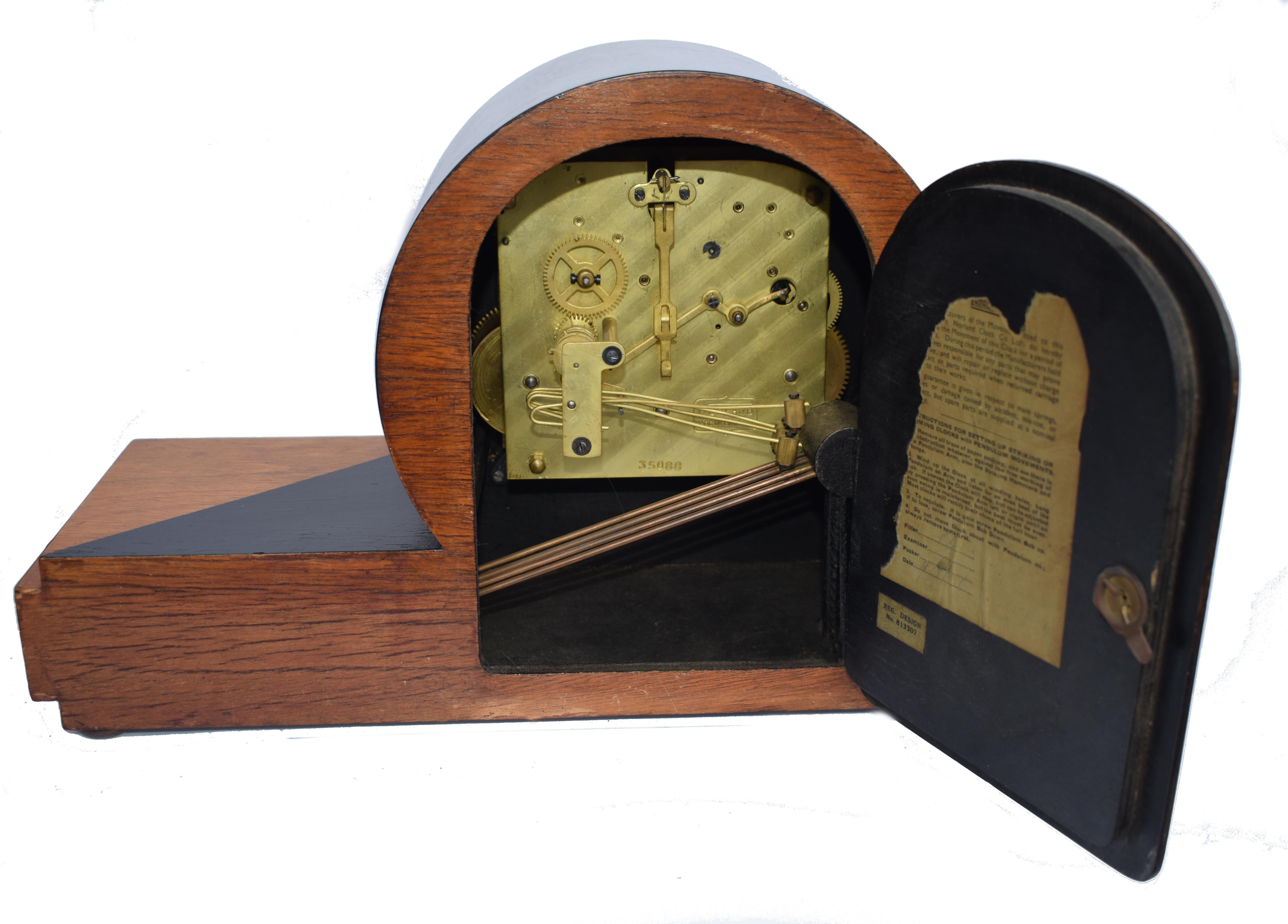 For your consideration is this very stylish 1930s Art Deco Westminster chime clock by Norland, England. Multi colored wood with geometric lightening pattern to the from case and dial and bakelite feet to the front. The movement strikes the 1/4 hours