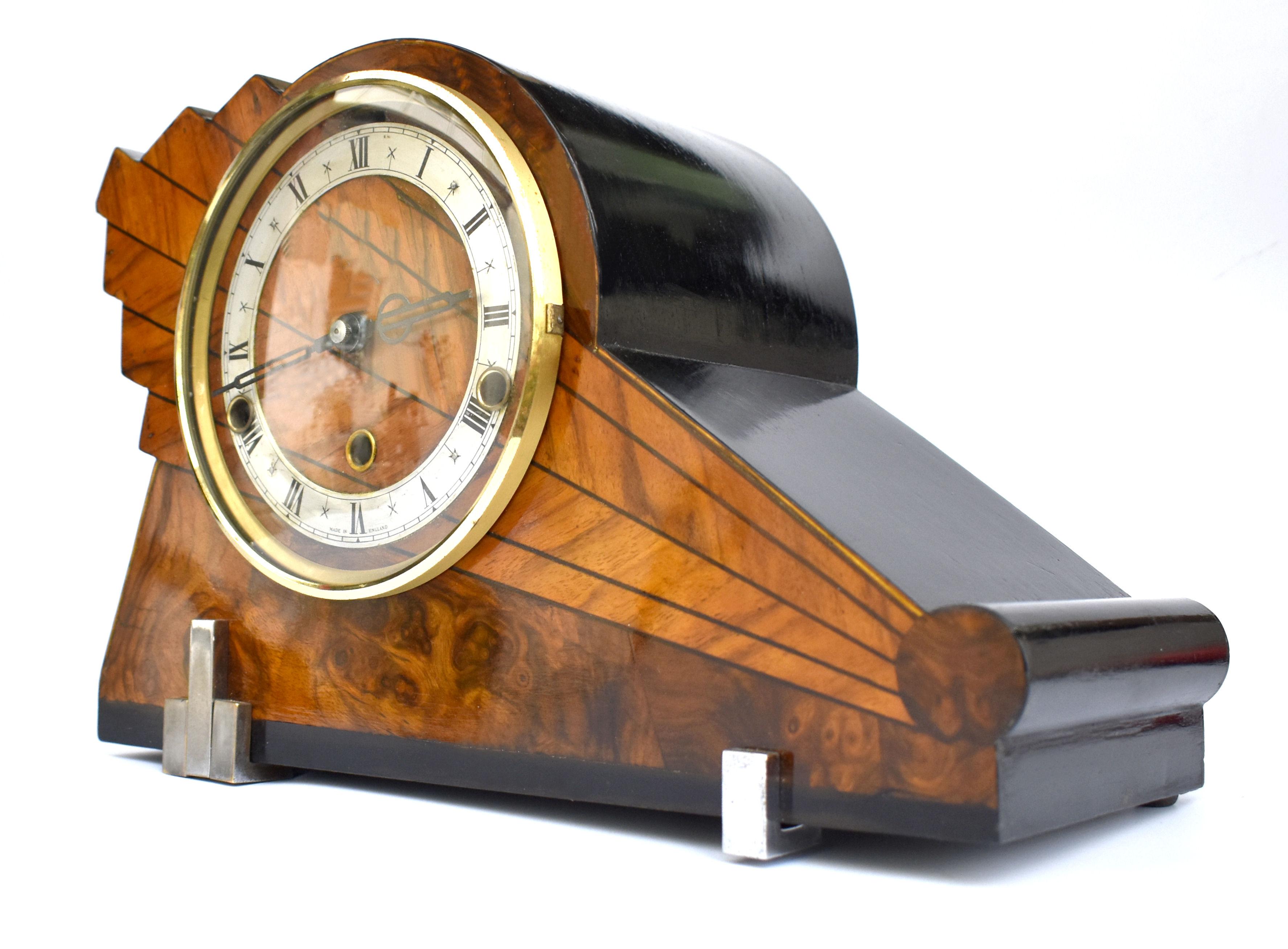 For your consideration is this very stylish 1930's Art Deco Westminster chime clock made in England. Multi toned walnut veneers with ebonised surround and a with geometric lightening shape to form the case this clock really does make a statement .