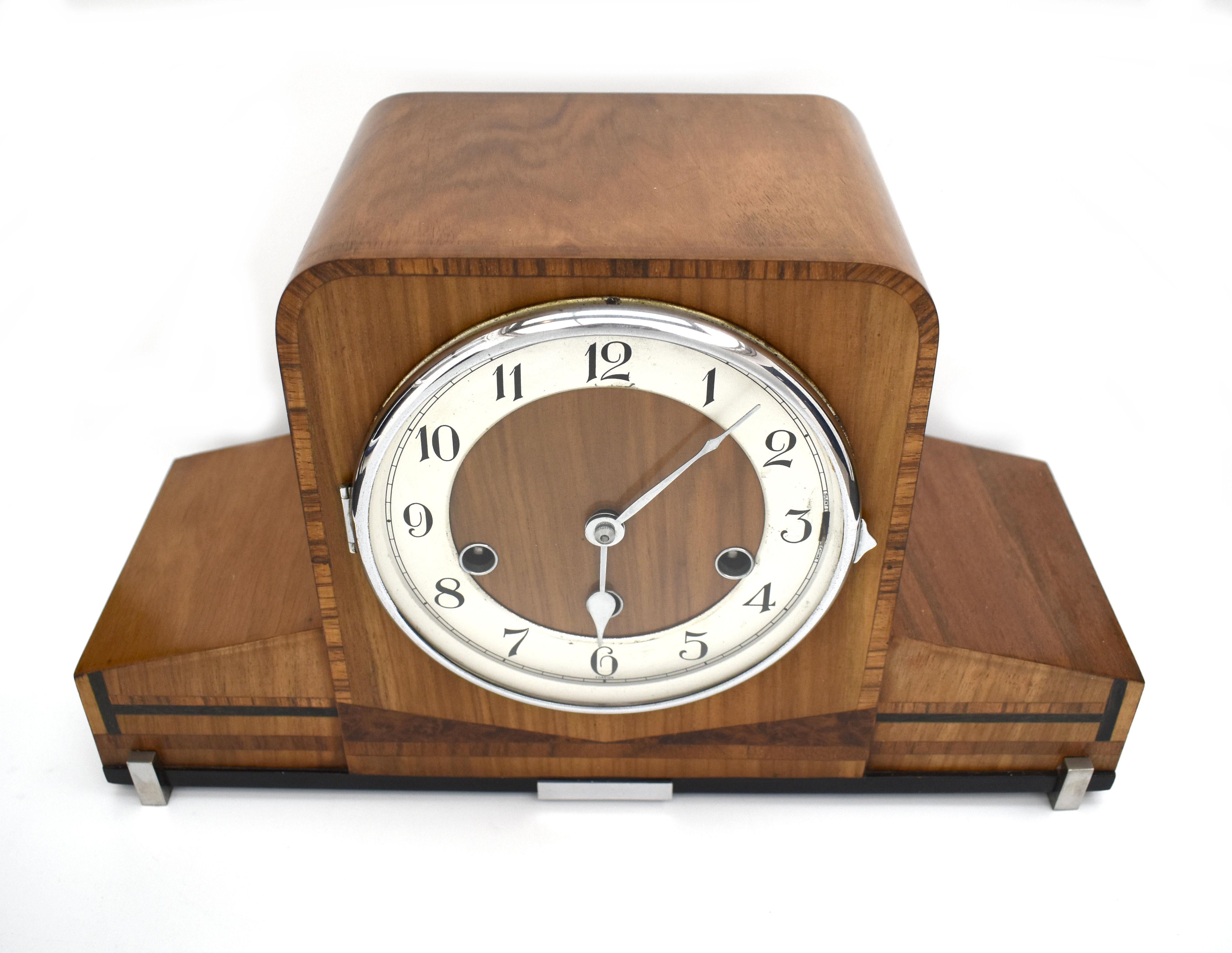 A magnificent and original Art Deco mantle clock for your consideration, Circa 1930. Stunning profile, having a high squared centre and slender, tapered wings. Reminiscent of the golden age of flight. Attractive inlay, using ebony, fruitwoods and