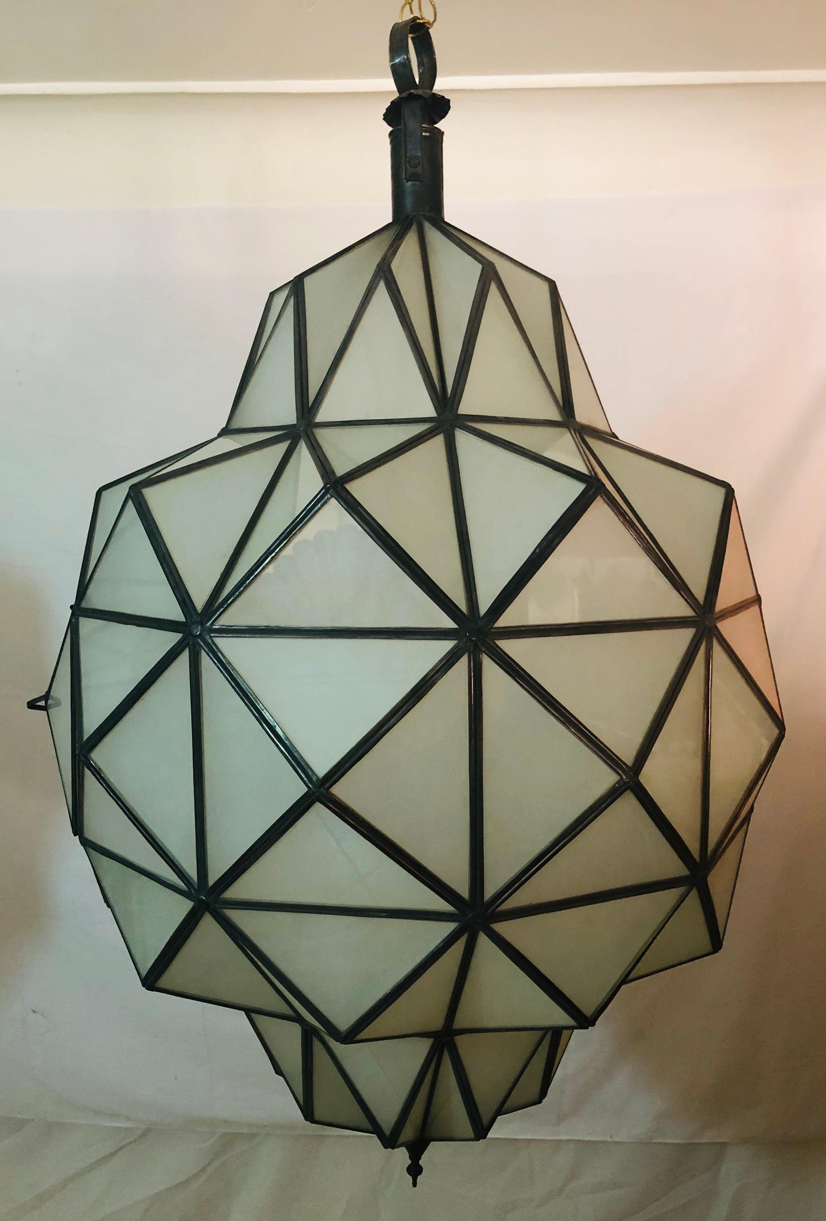 A stunning pair of Art Deco style dome form milk glass white chandeliers or lanterns. Each having individual panes, possessing an open door pane leading to a double recently wired setting housing two sixty watts bulbs. These fine custom lanterns are