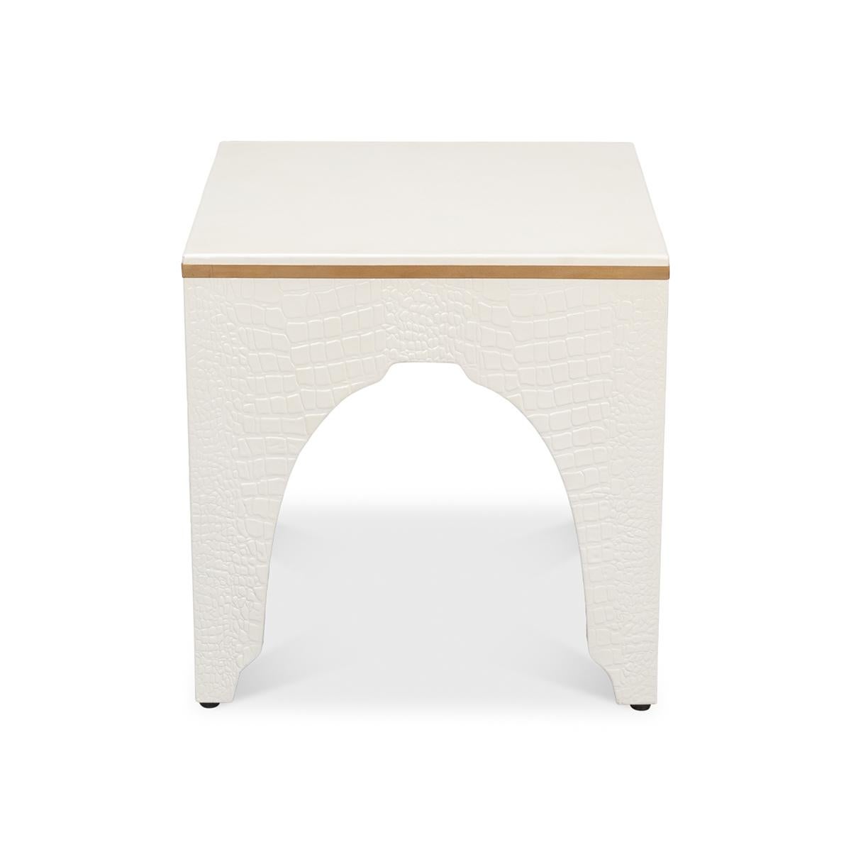 A testament to timeless elegance and luxury. Wrapped in sumptuous leather with a radiant white pearl croc finish, this ivory-hued stool exudes a refined charm that elevates any interior space.

Its sophisticated design, reflecting the grandeur of