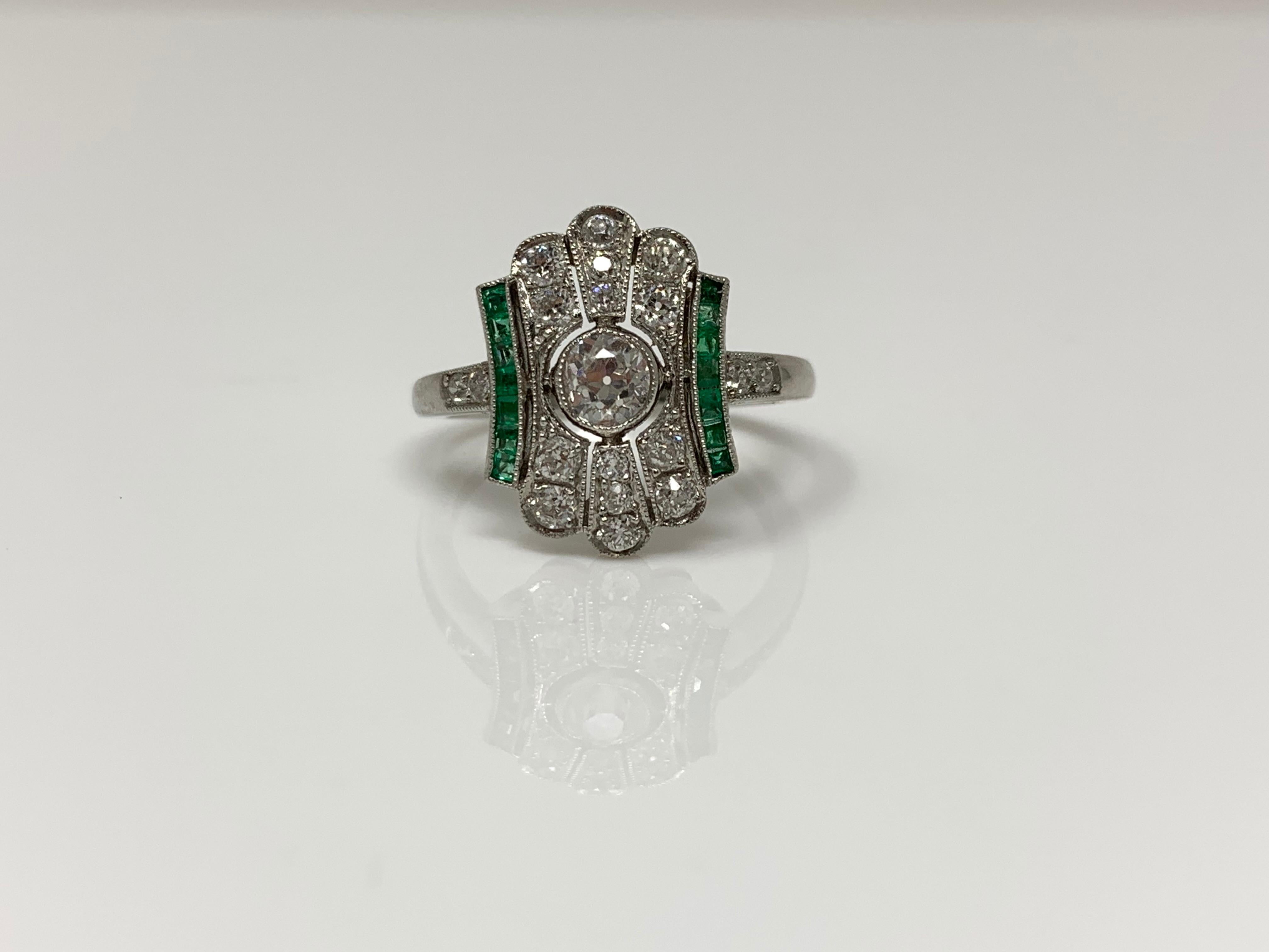 This gorgeous art in style deco ring is set with diamond and emerald. The ring is wonderfully hand crafted in platinum with diamonds weighing 0.80 carat with GH color and VS clarity  and emerald weighing 0.30 carat. The ring size is 6 and can be