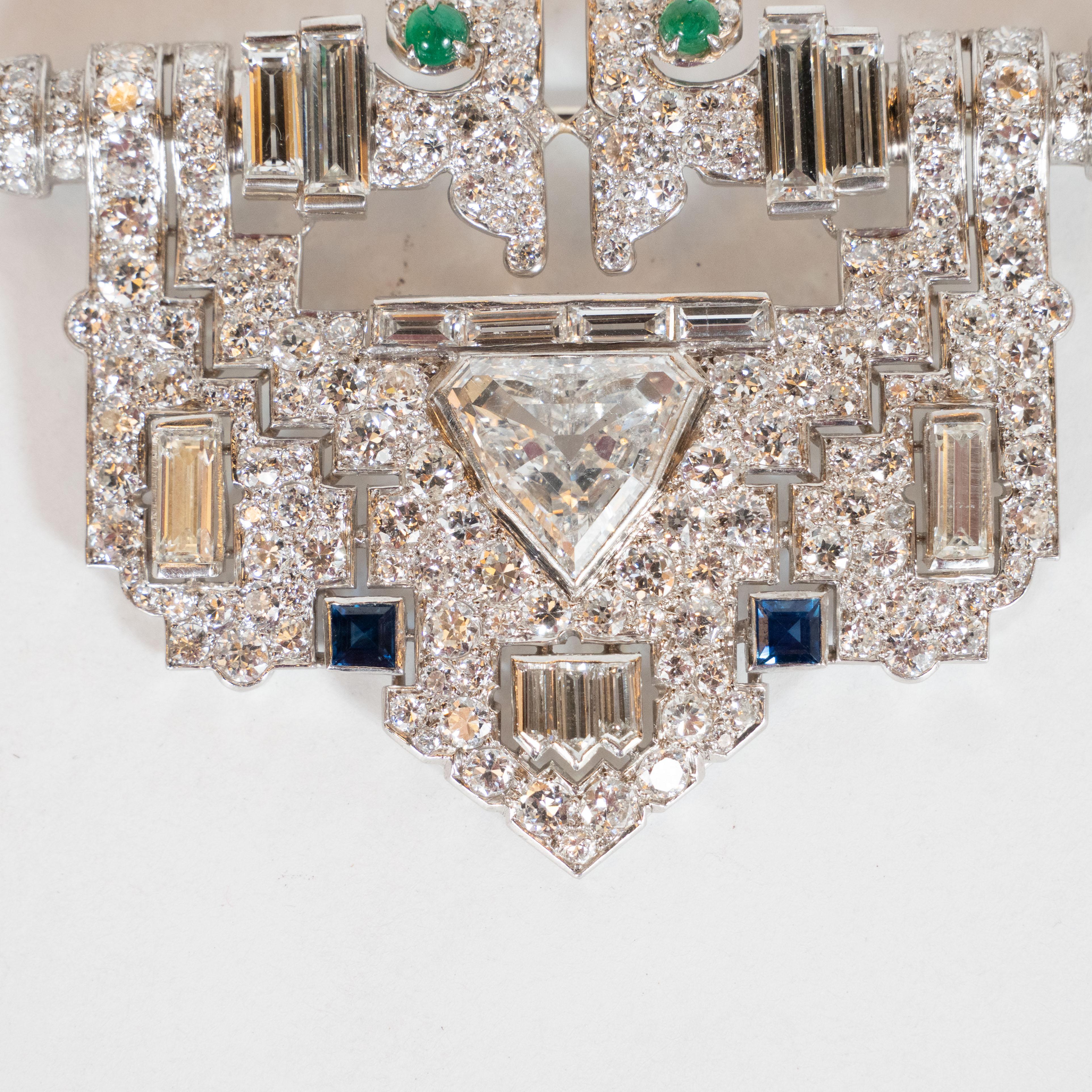 This gorgeous skyscraper style Art Deco clip brooch was meticulously hand crafted in the United States, circa 1930. Boasting an impressive total diamond weight of 12.5 carats, this piece offers a rectangular body with a pyramidal form at the base,