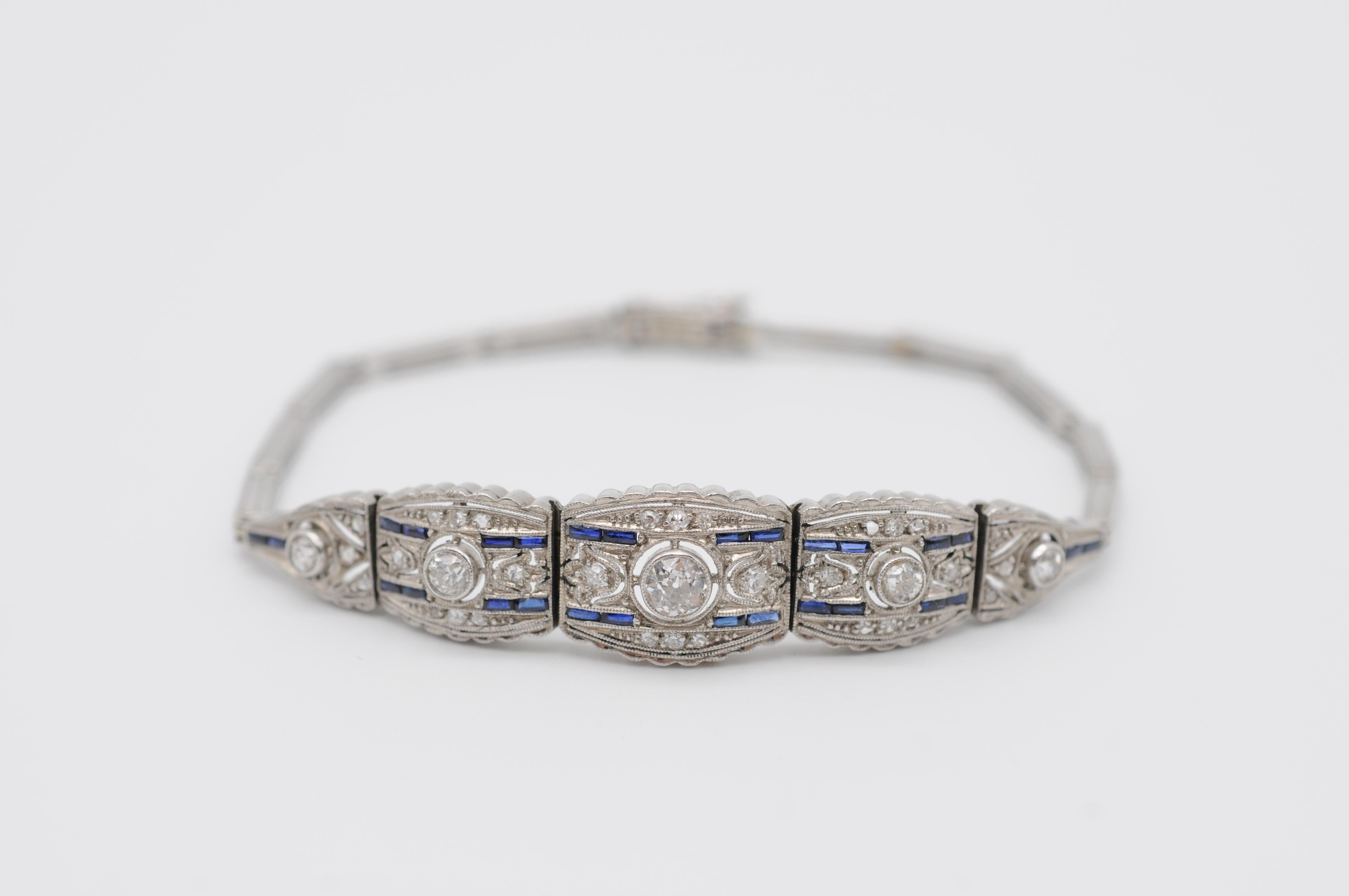 Step into the lavish world of Art Deco with this stunning bracelet, a true masterpiece of fine jewelry. The bracelet is crafted from solid 14k white gold and features a gorgeous openwork design that exudes elegance and sophistication.

The