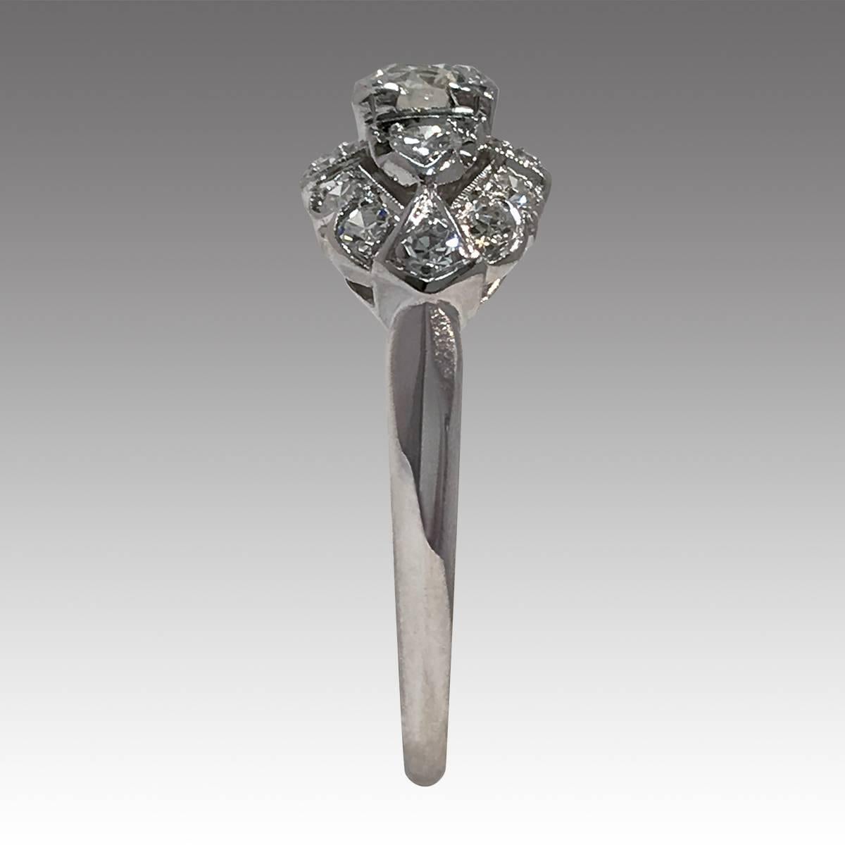 Art Deco 18 Karat White Gold Diamond Ring, 0.78 carat, round 0.40 carat center diamond set in a square corner setting with smaller accent single-cut diamonds surrounded with milgrain detailing. Diamonds are SI1-SI2 (G.I.A.) in clarity and F-G