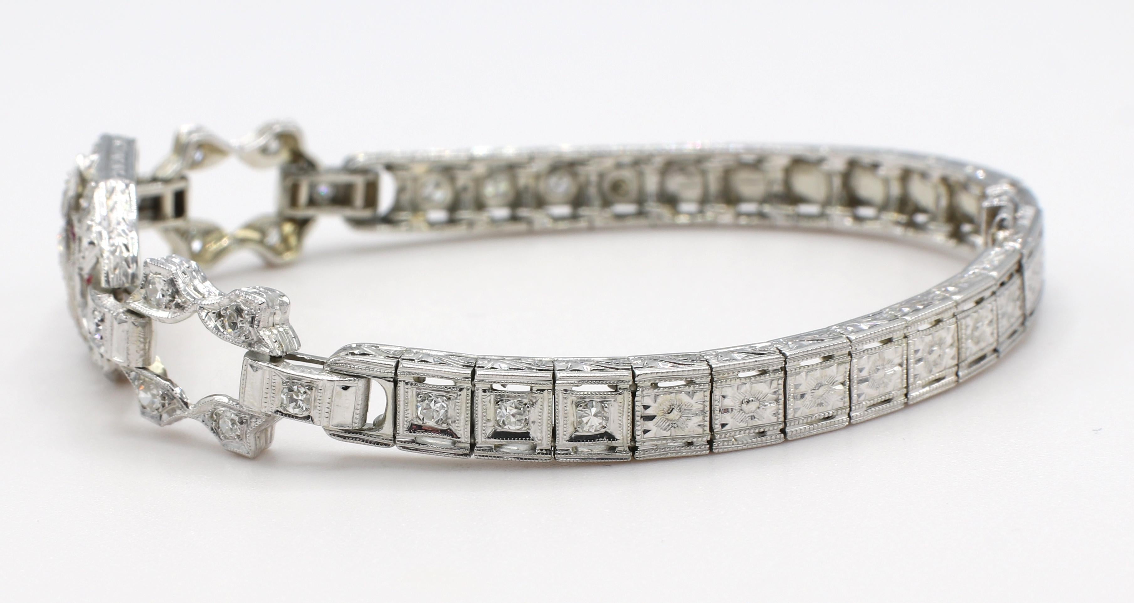 Art Deco White Gold Diamond & Ruby Bracelet 
Metal: 14k white gold
Weight: 15.8 grams
Diamonds: Approx. 1 CTW Old European cut and single cut round diamonds G-H VS
Length: 6.5 inches
Width: 5.5 - 13mm