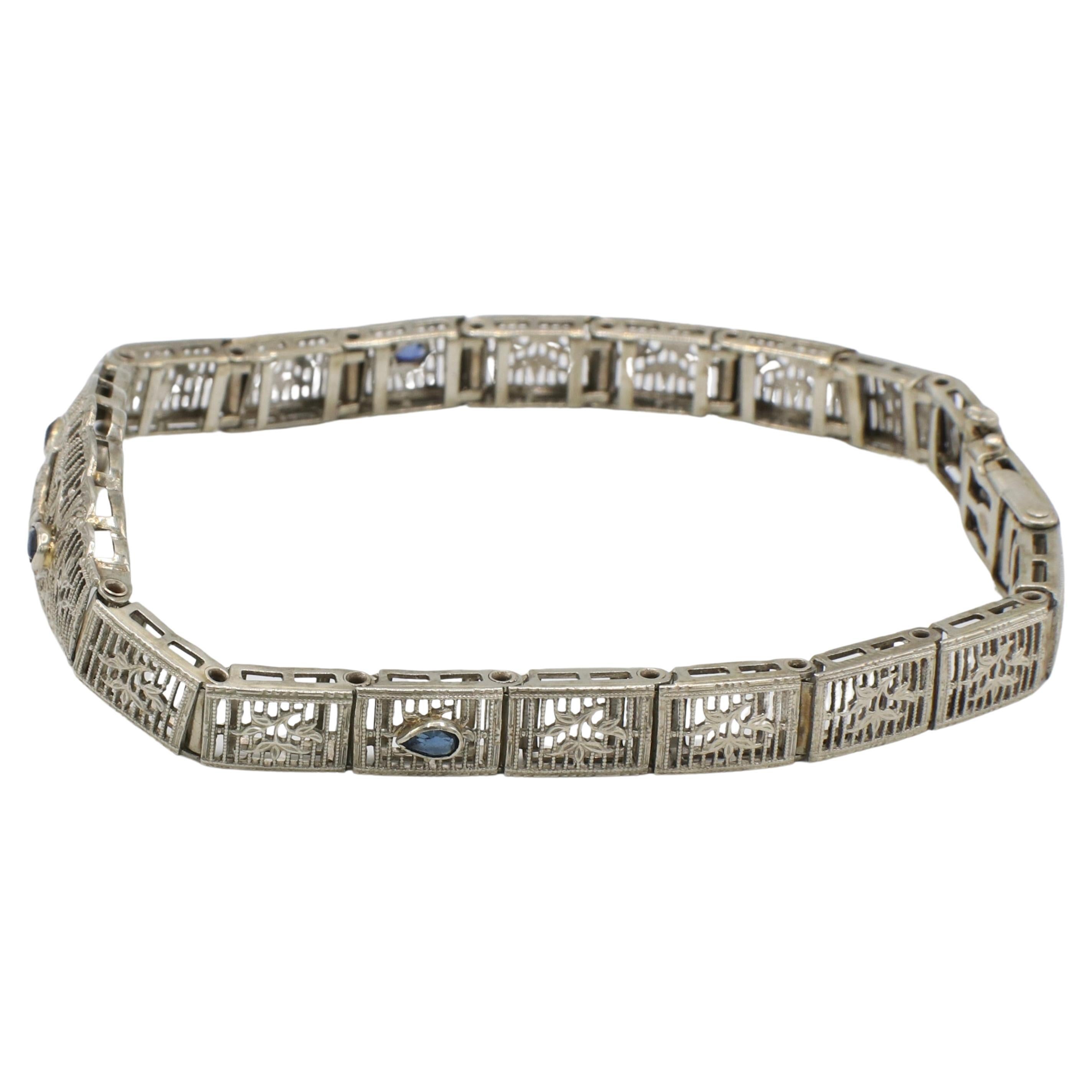 Art Deco White Gold Filigree Natural Diamond & Sapphire Belly Bracelet 
Metal: 10K white gold
Weight: 9.2 grams
Length: 7 inches
Width:6-13mm
Diamonds: 1 round single cut natural diamond, approx. 0,1 CT G-H VS
Sapphires: Period reproduction