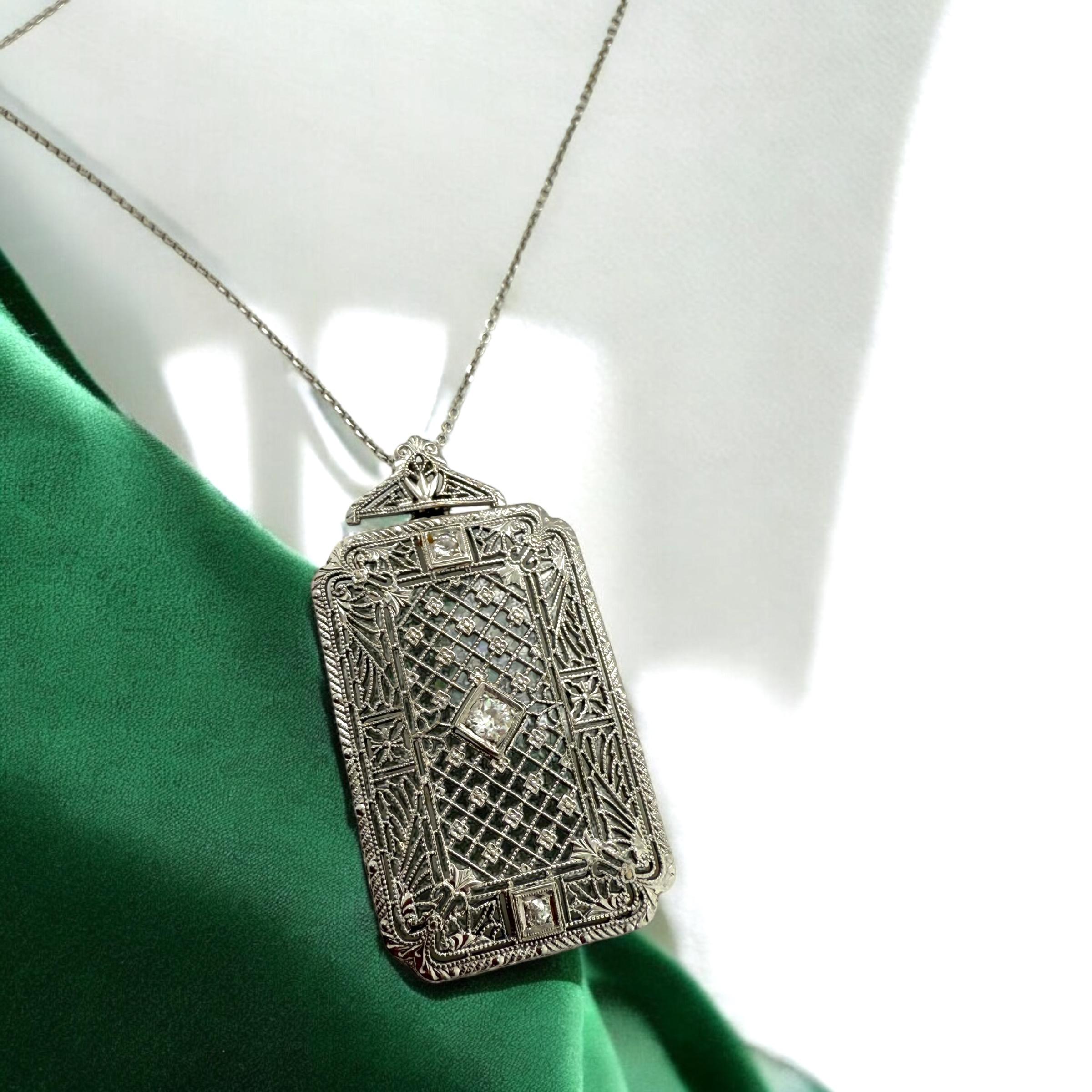 We are loving this detailed beauty!
The filigree is simply stunning!

Necklace Details
Material: 14K White Gold
Era: Art Deco 1920 - 1940
Pendant Measurements: 1 5/8 Inch X 7/8 INCH
Chain Length: 18 Inches
Weight: 6.7 Grams

Accented by the