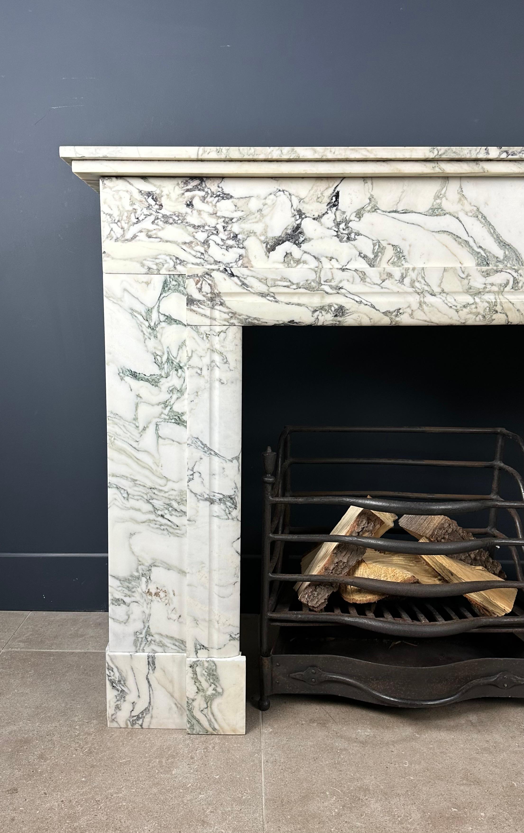 Enter an era of opulent sophistication with our Antique Art Deco Fireplace in white marble. The matchless combination of beautiful green-gray veining and distinctive Art Deco style makes this fireplace a visual masterpiece and a tribute to a bygone