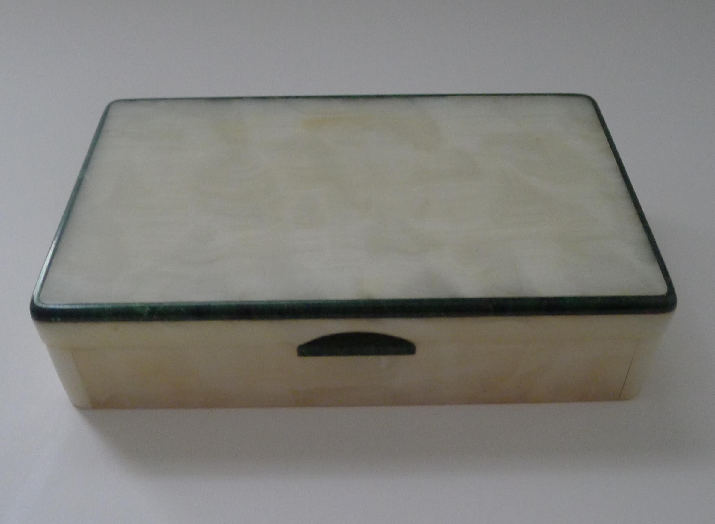 A fabulous smart Art Deco box made from white onyx and trimmed in a deep green Malachite.

The box opens to reveal the gold plated Betjemann's Patent hinge with and English registration number for the year 1906, this box made around 1930/1930; also