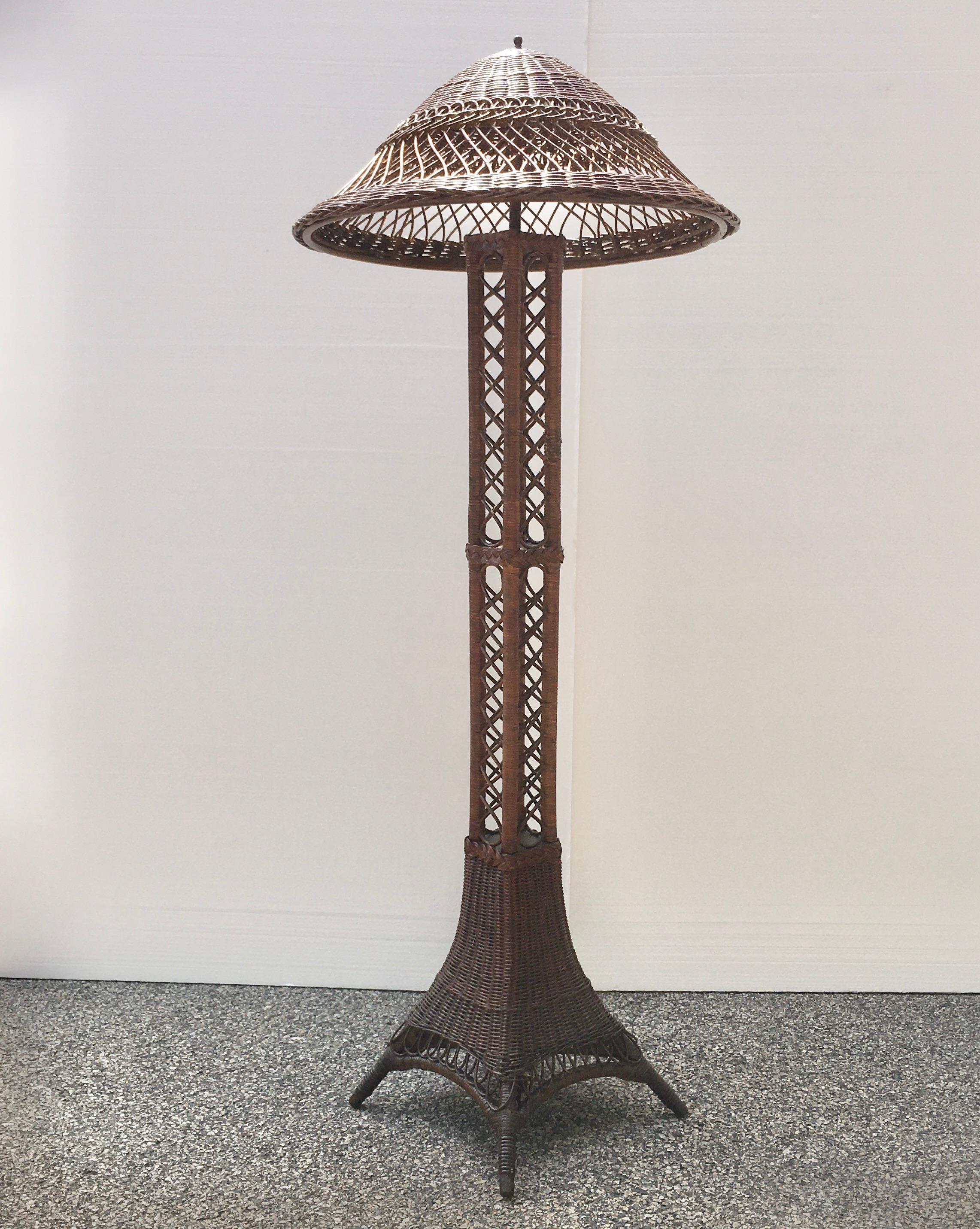 Antique wicker floor lamp in Eiffel Tower form embellished with beautiful braided banding, attributed to Heywood Wakefield.
Double brass sockets with pull chains, takes two standard size Edison screw light bulbs.
Measures: Overall height 69