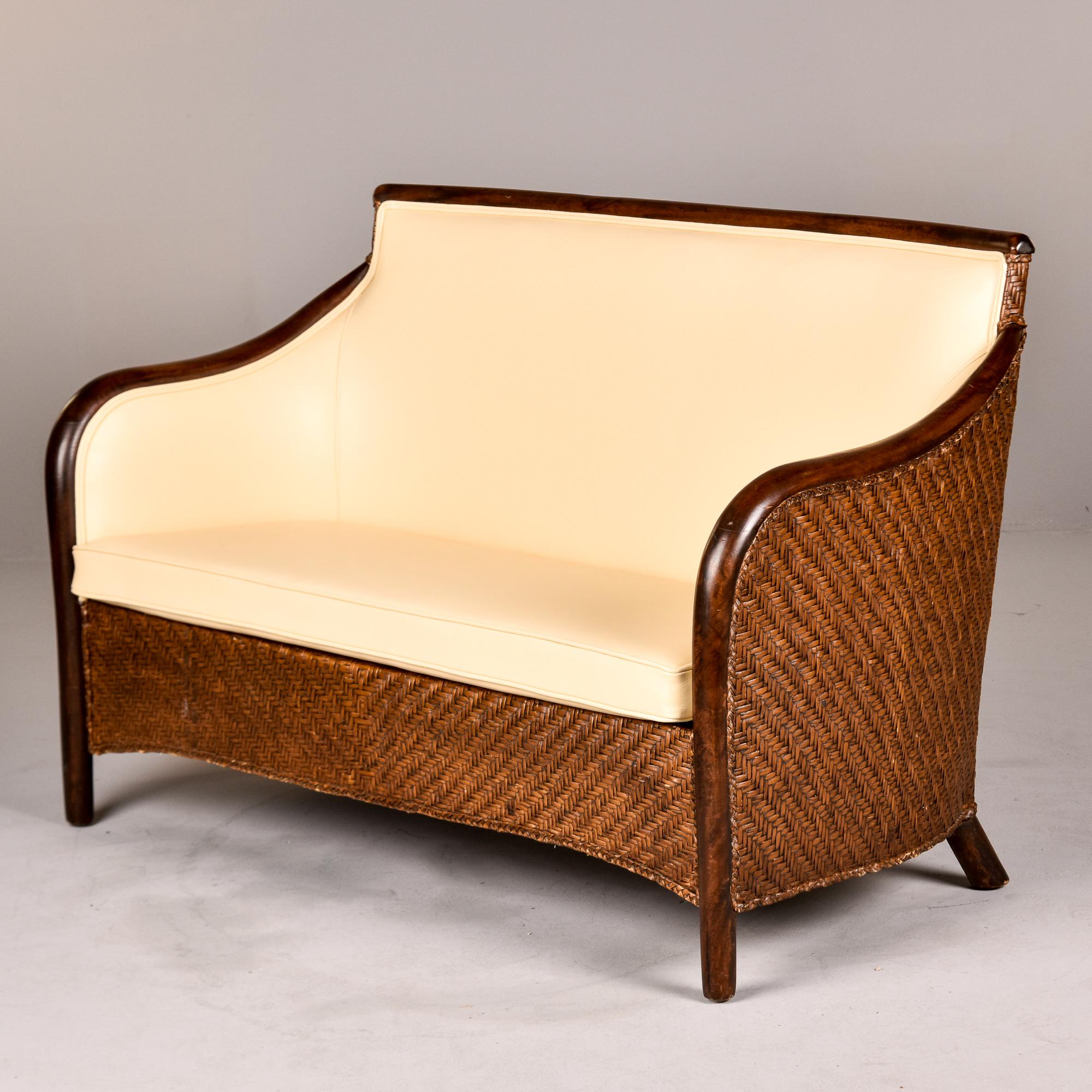 Found in Italy, this wicker and bentwood frame sofa dates from the 1940s. We had it reupholstered in a creamy, ivory colored leather. Unknown maker. Coordinating pair of chairs in same style / upholstery available at the time of this posting in a