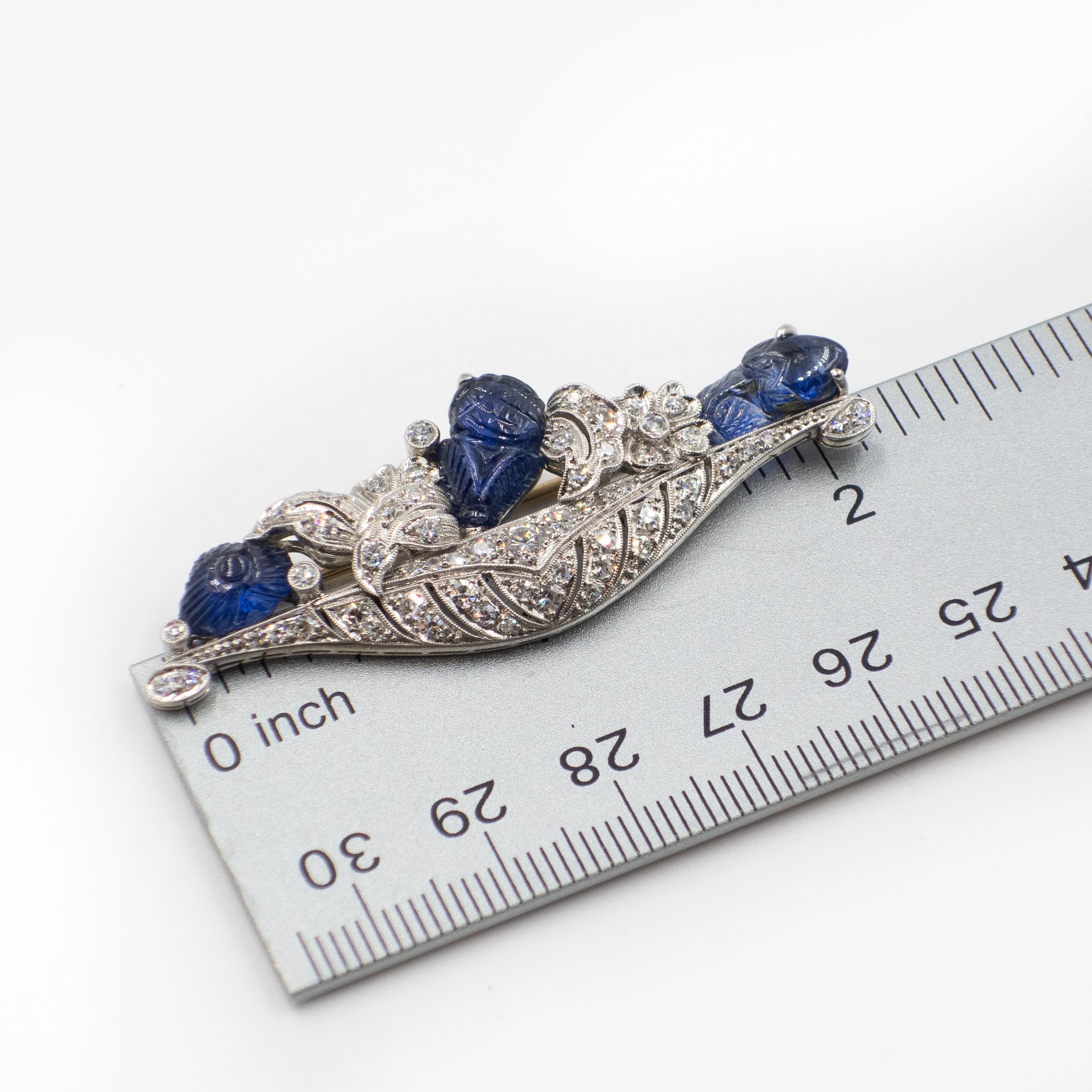 Stunning Art Deco Williams Wise & Son platinum carved sapphire diamond flower basket motif brooch set with 3 natural sapphire approximate 4 - 5 carats and 58 sparkling old European cut and single cut diamonds approximate 2.00 carats in H-I color VS2