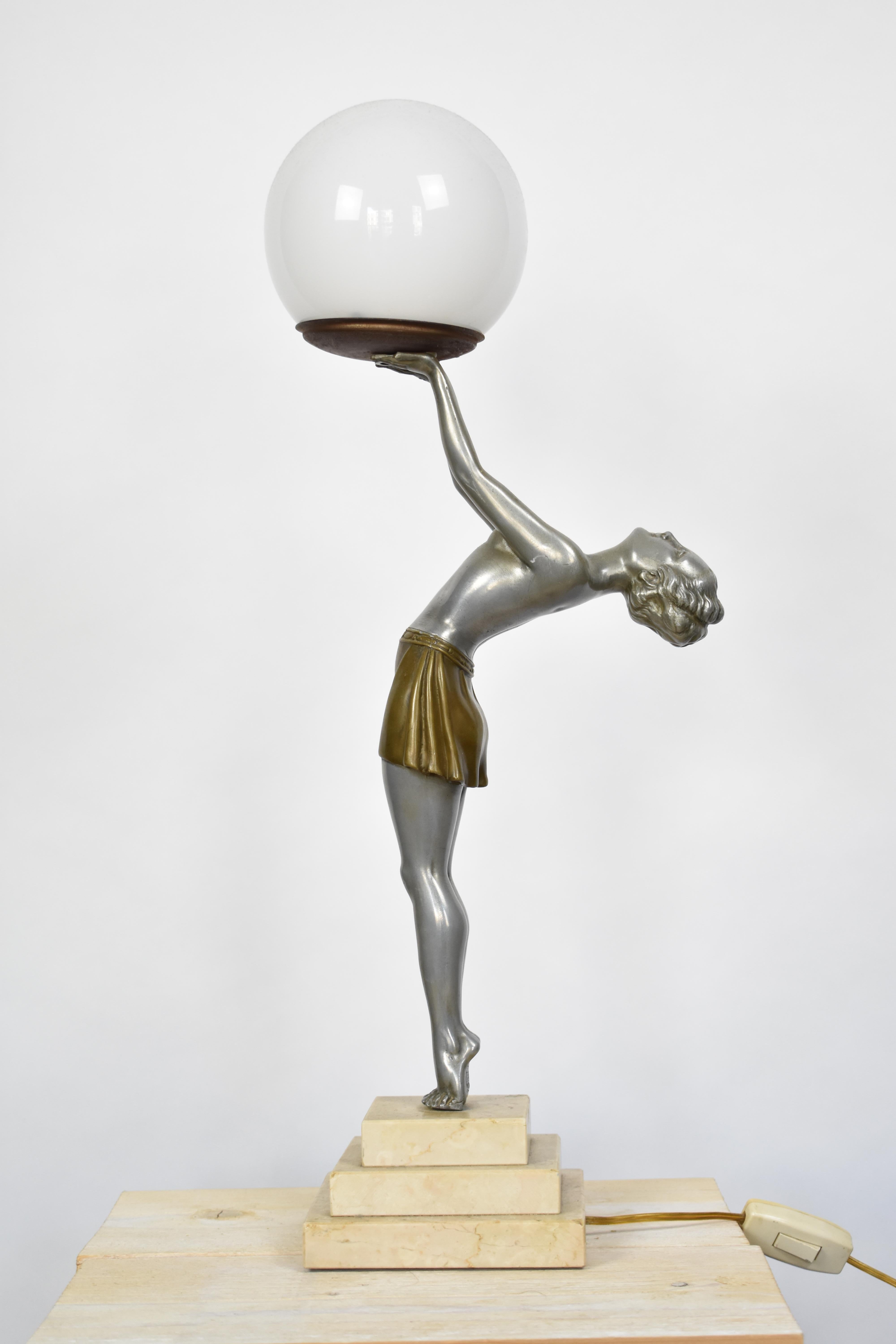 Information:
This original Art Deco piece features a nude woman holding a glass globe over her head. The globe lights up when turned on. The lamp is in the style of the famous Max Le Verrier lamps. However it is made by Enrique Molins-Balleste and