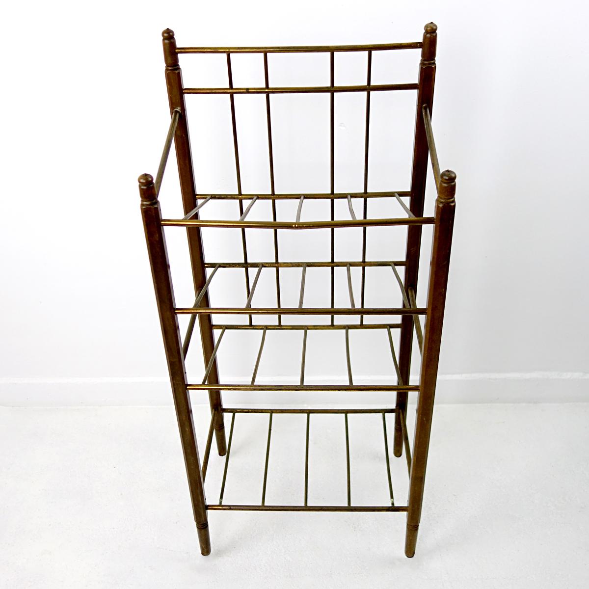 This Art Deco magazine stand was produced by Ernst Rockhausen & Söhne. 
Its frame is made of ebonized mahogany and it has brass tubes to carry your magazines. 
This elegant piece would be both a practical as a decorative element in your living,