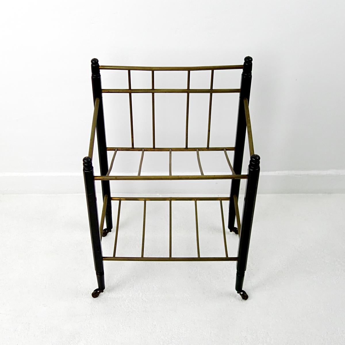 This Art Deco magazine stand was produced by Ernst Rockhausen & Söhne.
Its frame is made of ebonized mahogany and it has brass tubes to carry your magazines.
This elegant piece would be both a practical as a decorative element in your living, den