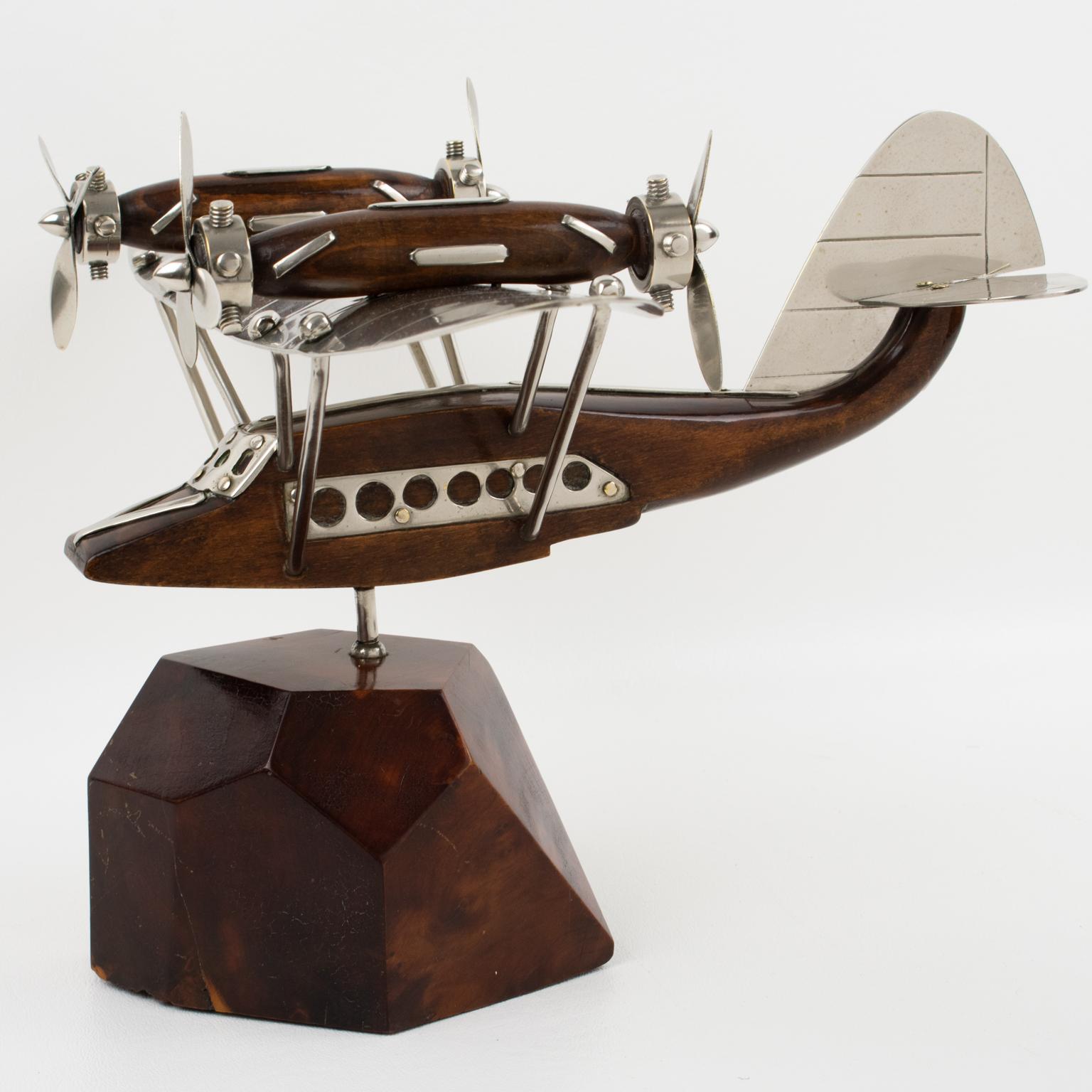A fantastic French Art Deco chrome and wood airplane/seaplane model mounted on a stylized wood plinth. A superbly crafted rendering of the legendary quadri-propellers seaplane, strikingly evocative of a golden age in air travel. This handsome 1940s