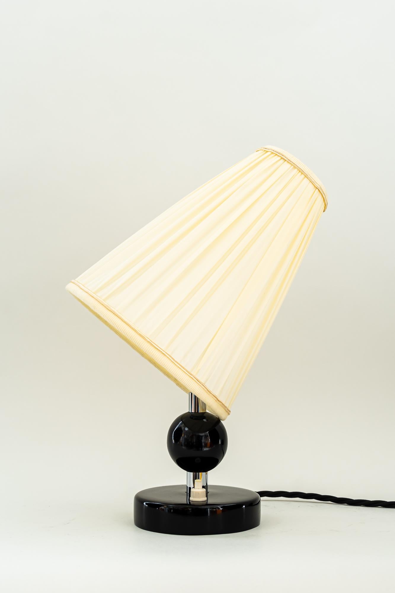 Art Deco wood base table lamp with fabric shades around 1920s
Nickel -plated 
Wood blackened 
Fabric shades are replaced ( new ).