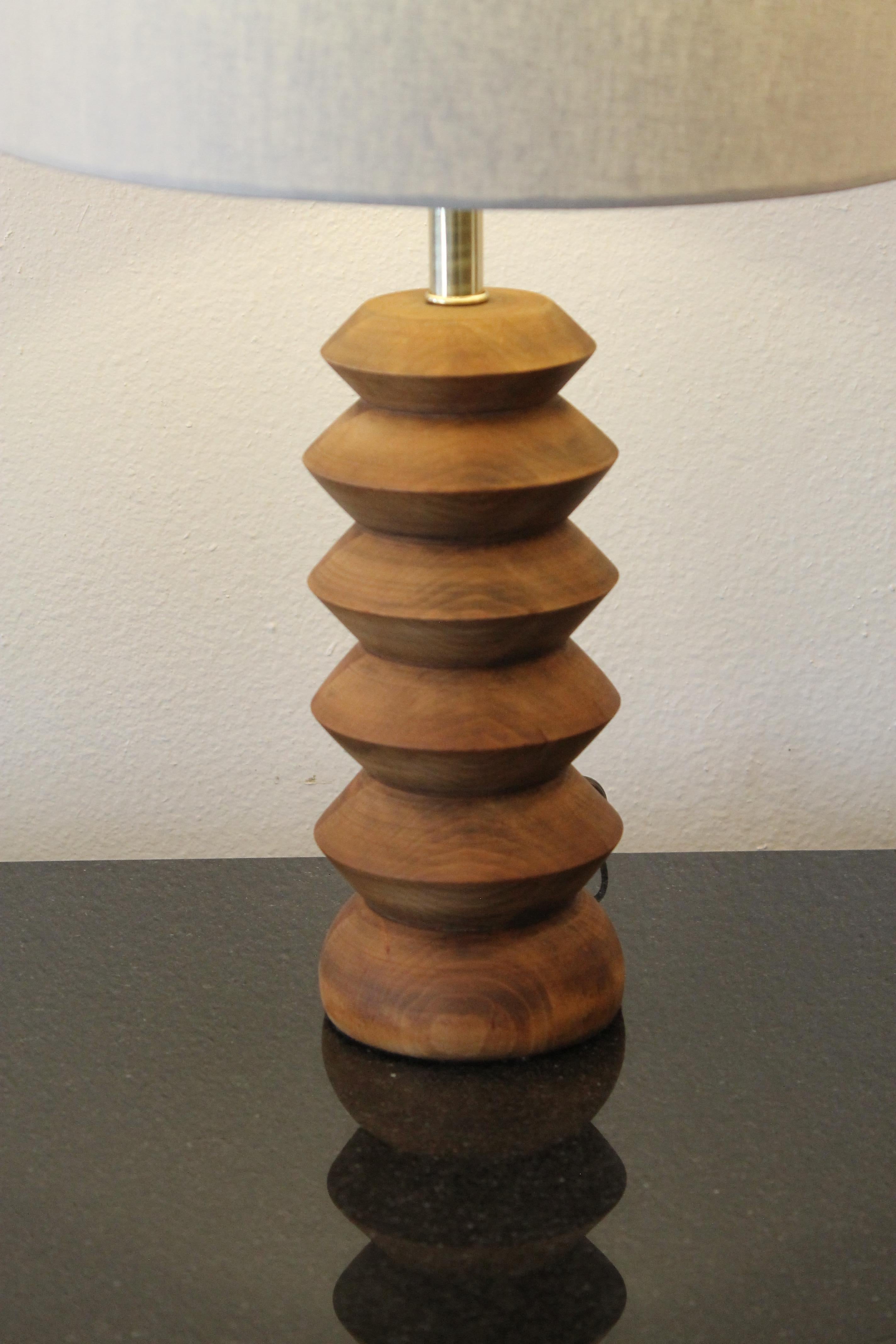Art Deco wood lamp consisting of stacked wood disks. Lamp measures 13.25