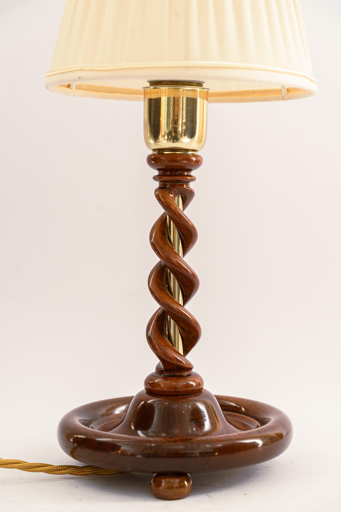 Art Deco wood lamp with fabric shade, Vienna, around 1920s.
Wood polished.
Brass polished and stove enameled
The fabric shade is replaced (new).